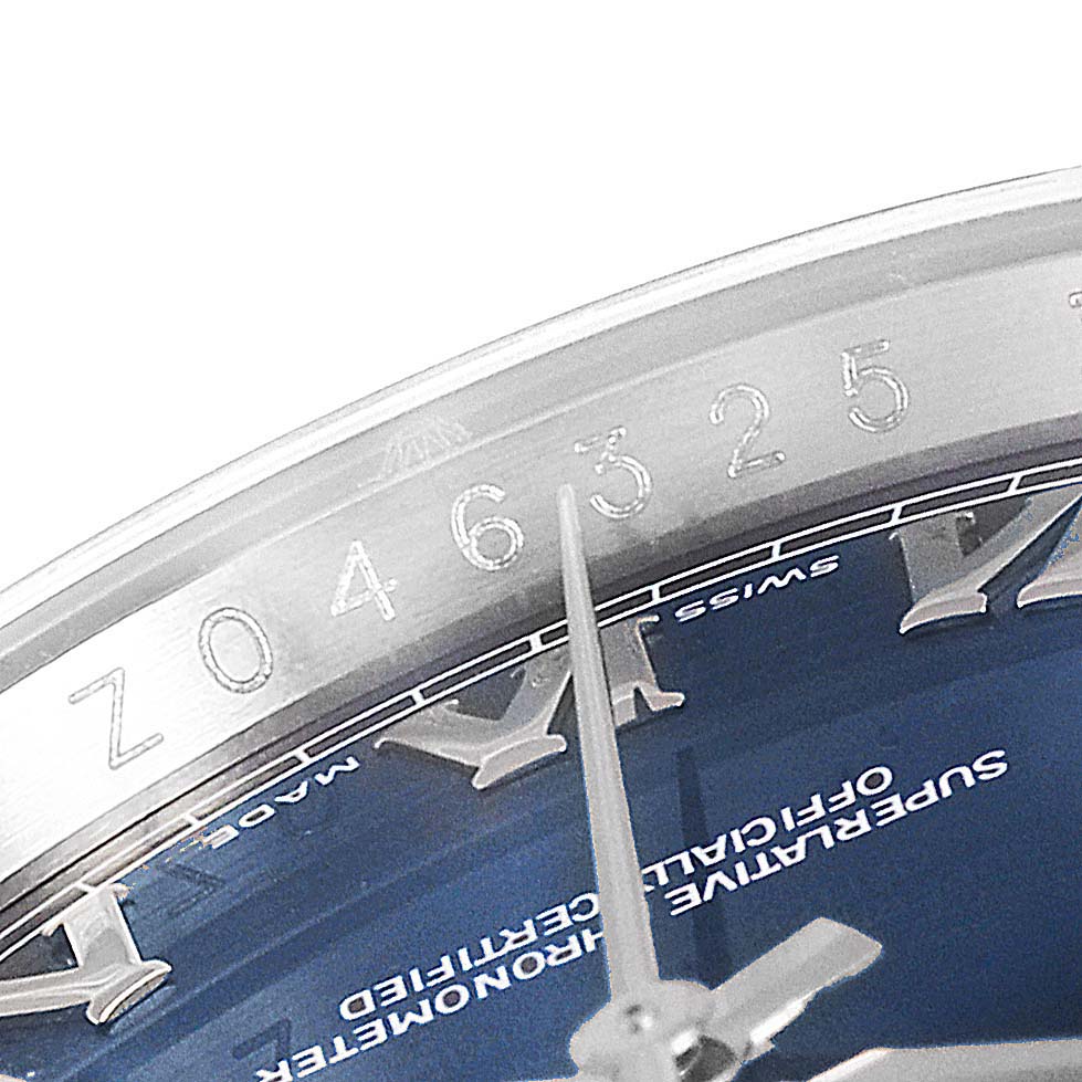 The image shows the partial face, hour hand, and serial number engraving on the rim of a Rolex Datejust 116200 Men's Stainless Steel Blue Dial 116200 Men's Stainless Steel Blue Dial watch.