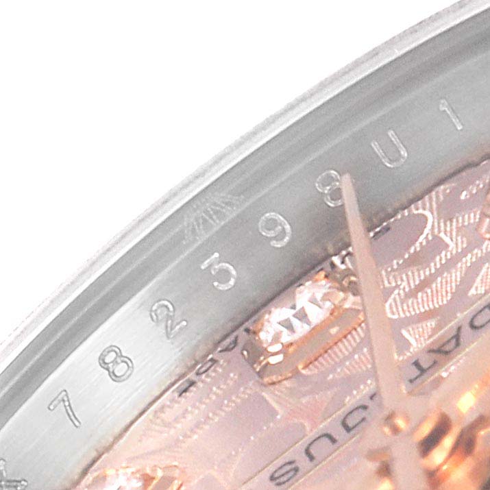 This close-up image of a Rolex Datejust 179171 Women
s Steel and Gold (two tone) Pink Dial 179171 Women
s Steel and Gold (two tone) Pink Dial watch shows part of the bezel and the date track.