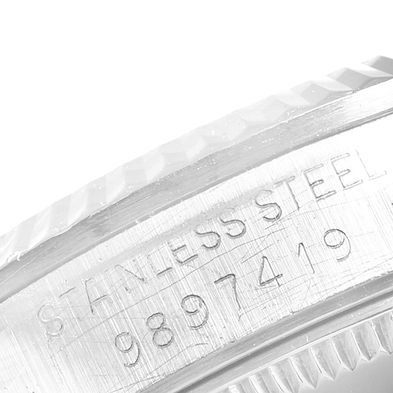 The image shows a close-up of the stainless steel case back with serial numbers of a Mid-Size Rolex watch.
