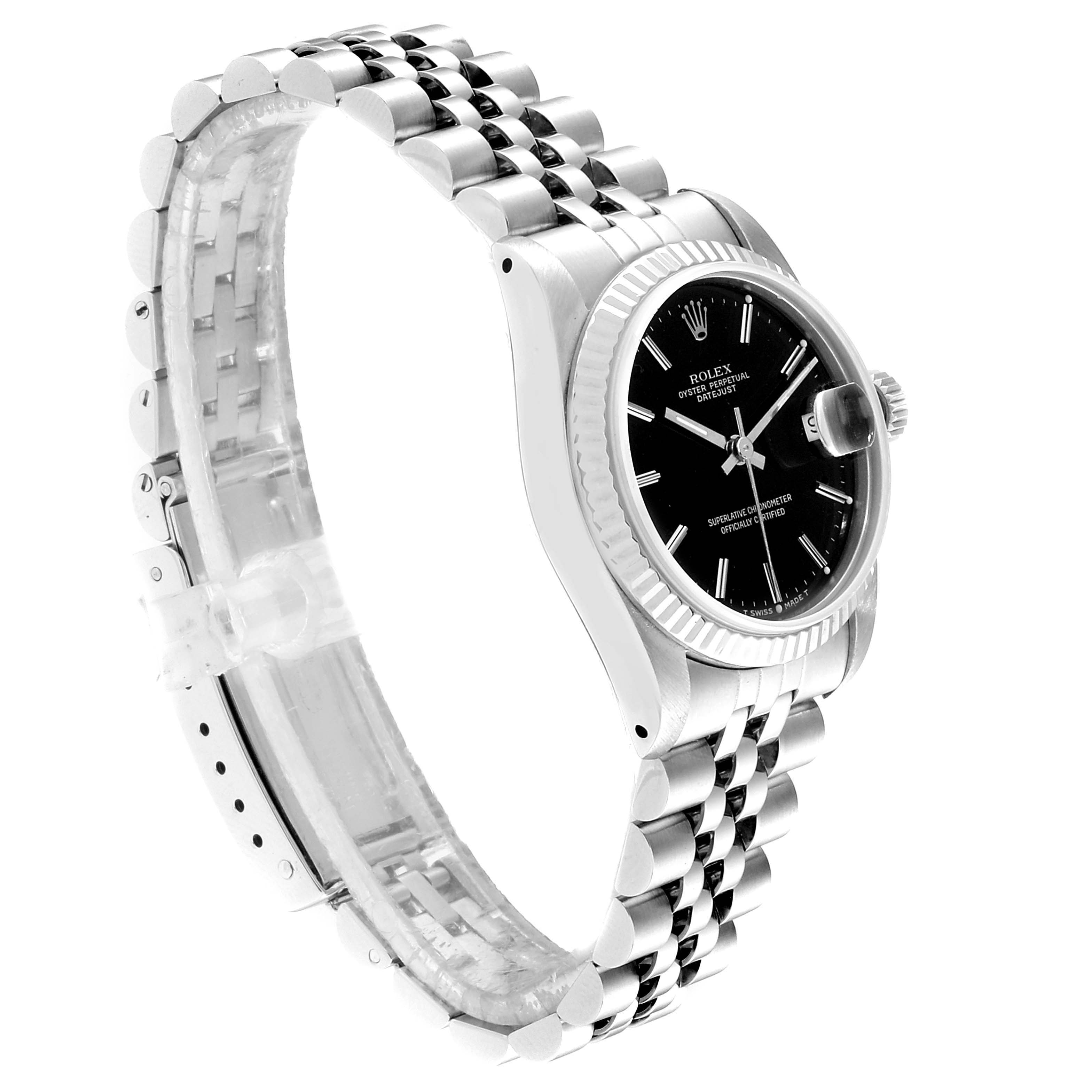 The image shows a side angle of a Rolex Mid-Size 68274 Women
s Stainless Steel Black Dial 68274 Women
s Stainless Steel Black Dial watch with a stainless steel bracelet and black dial.