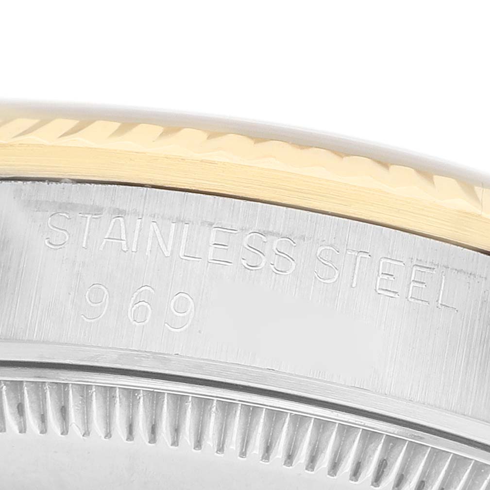 The image shows a close-up of the side of a Rolex Mid-Size 68273 Women's Steel and Gold (two tone) Champagne Dial model, focusing on the bezel edge and engraved text.