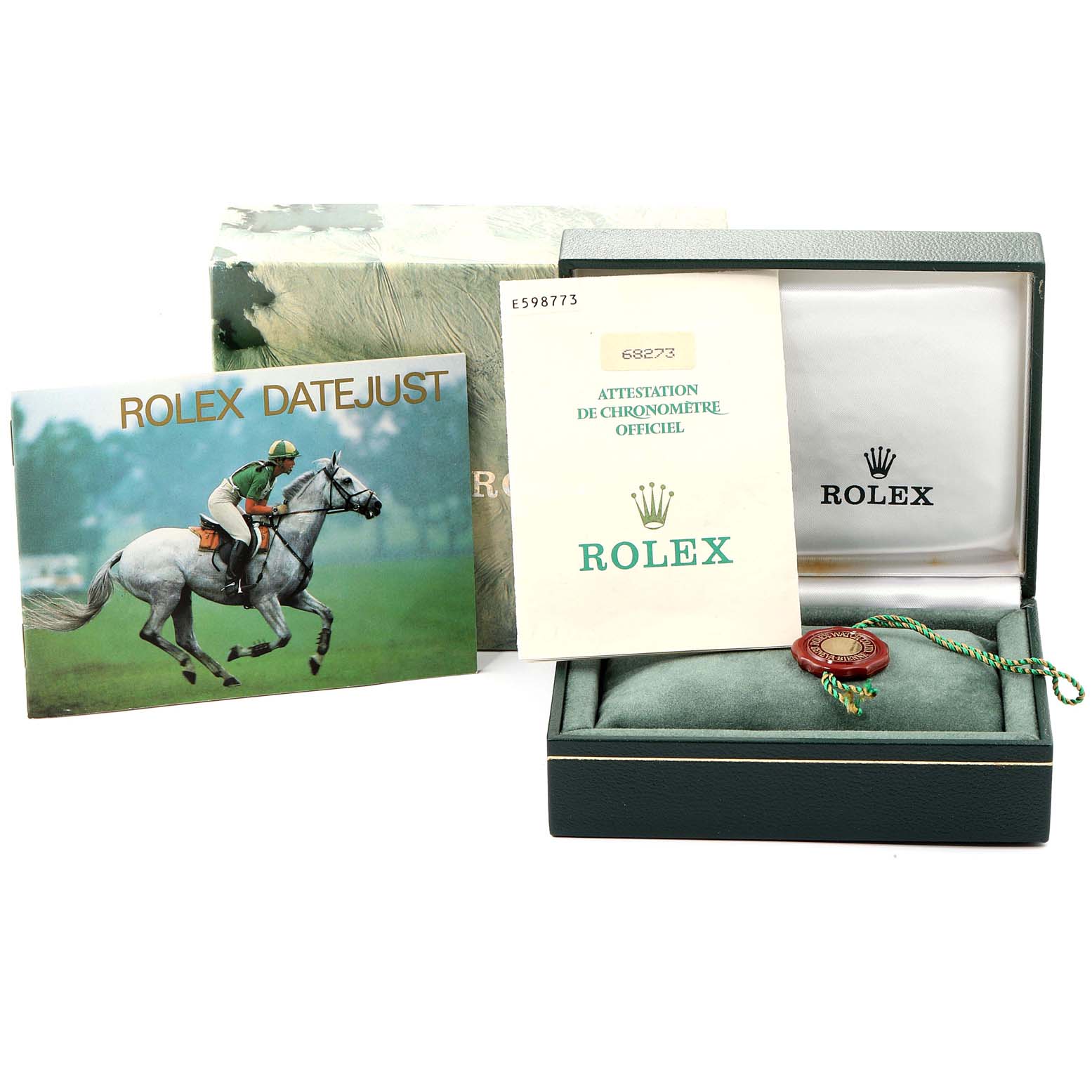 The image shows the packaging, booklet, certificate, and cushion for the Rolex Mid-Size 68273 Women
s Steel and Gold (two tone) Champagne Dial 68273 Women
s Steel and Gold (two tone) Champagne Dial Datejust model.