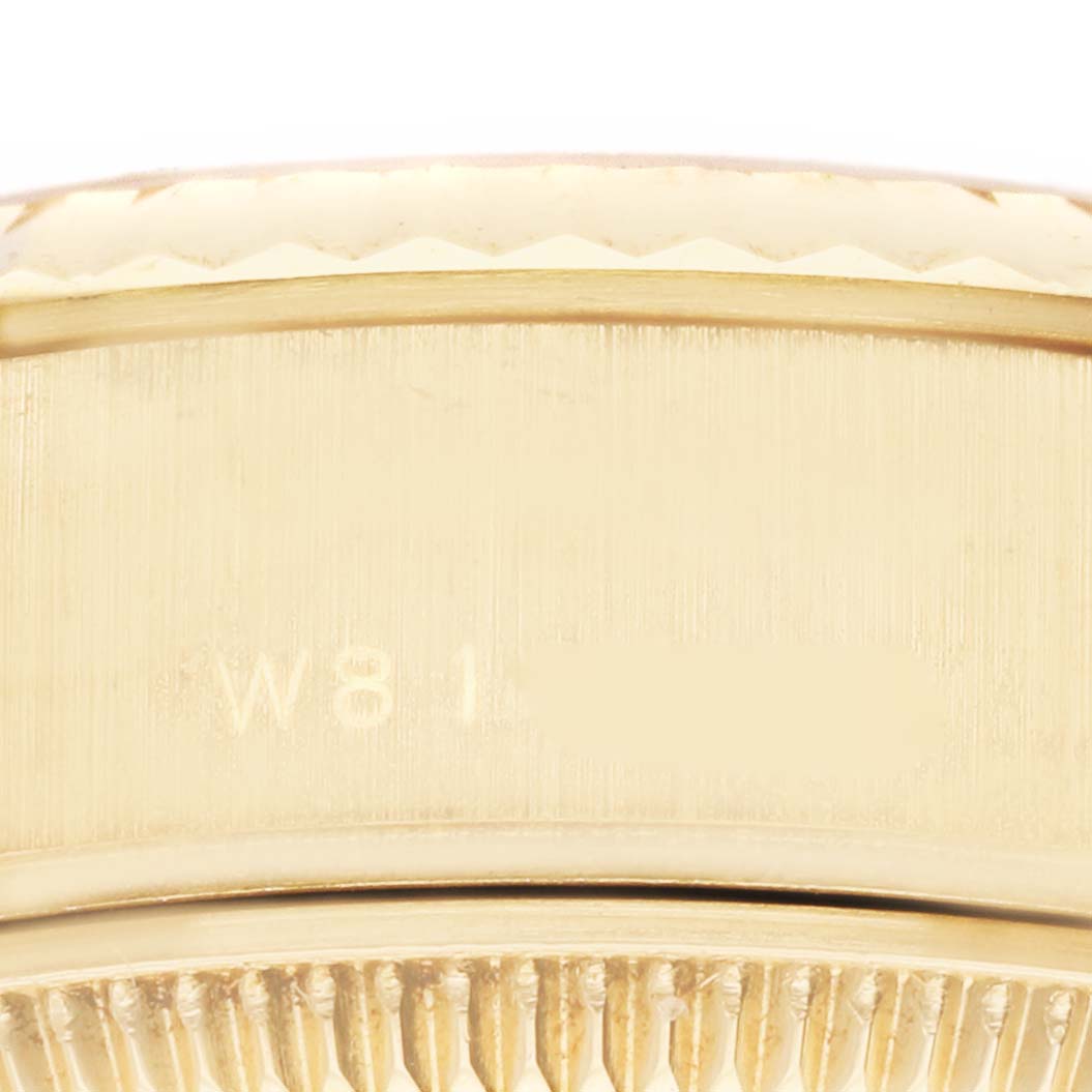 This close-up image shows the side of a Rolex President 69178 Women's Yellow Gold Champagne Dial 69178 Women's Yellow Gold Champagne Dial model's case with part of the serial number visible.