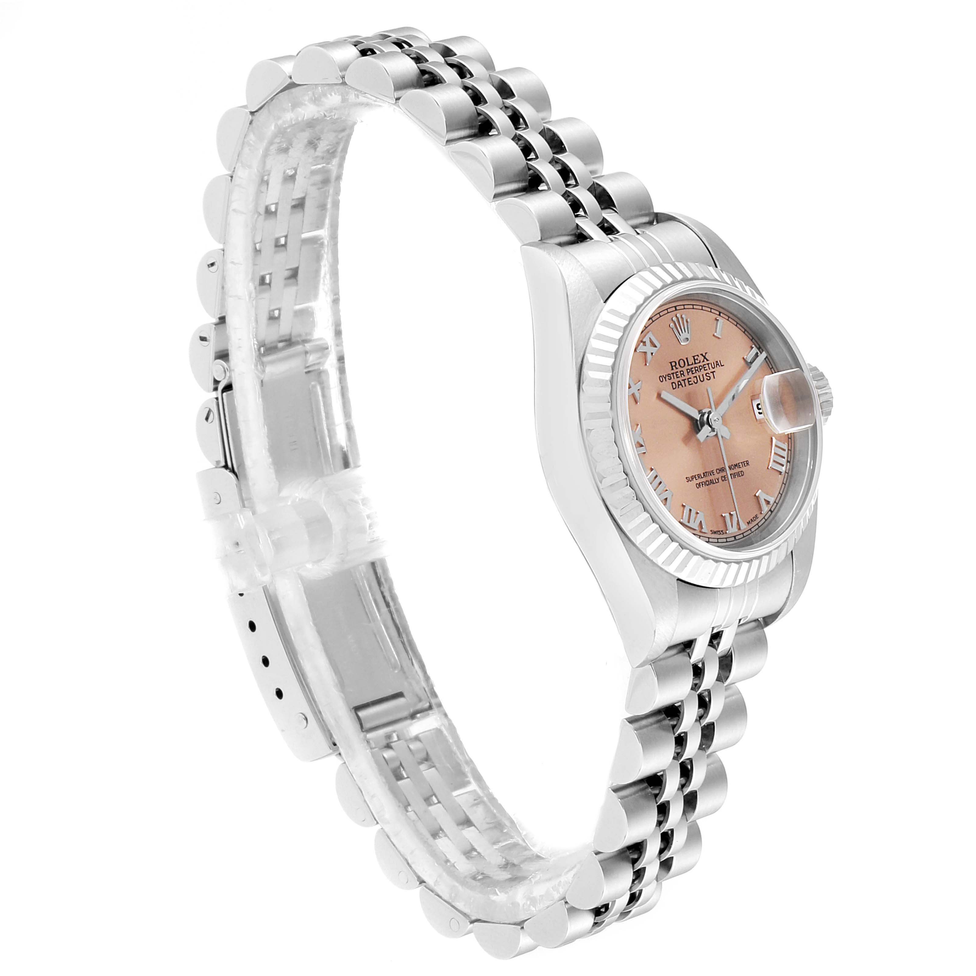 The Rolex Datejust 79174 Women
s Stainless Steel Pink Dial 79174 Women
s Stainless Steel Pink Dial watch is shown from a three-quarter angle, highlighting the pink dial, fluted bezel, and Jubilee bracelet.