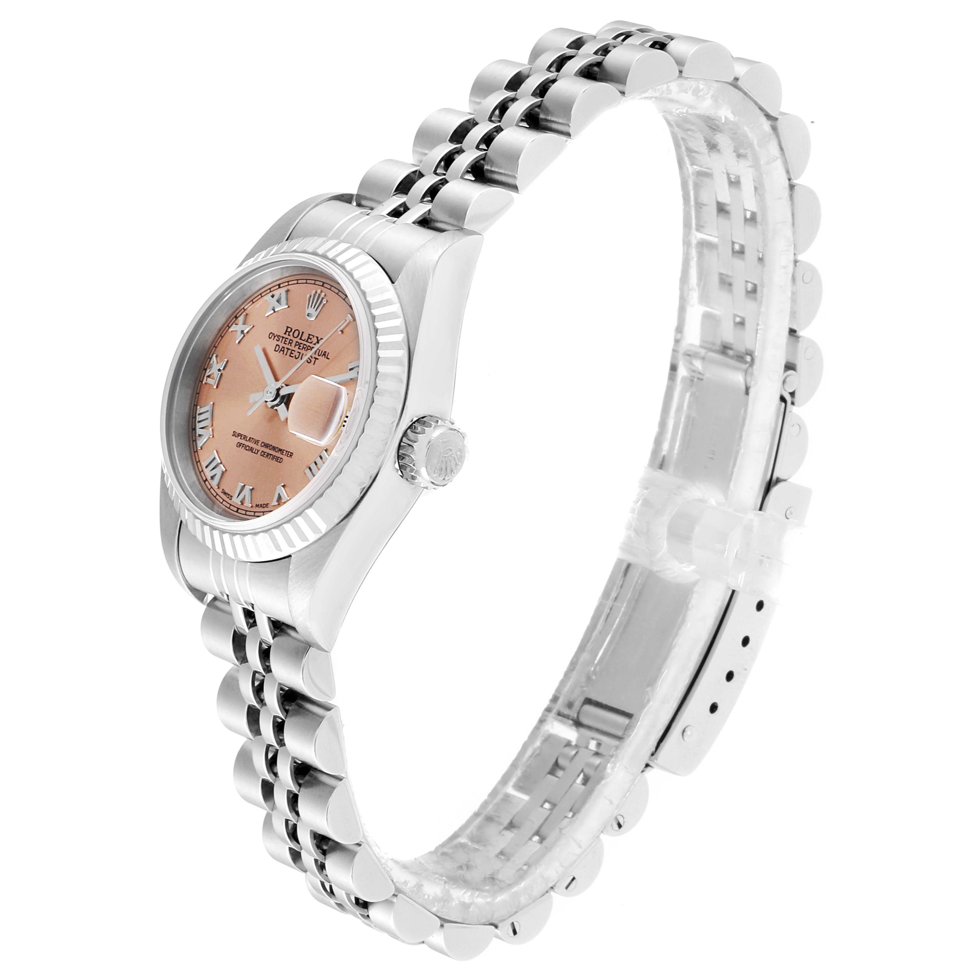 The Rolex Datejust 79174 Women
s Stainless Steel Pink Dial 79174 Women
s Stainless Steel Pink Dial watch is shown at an angled side view, displaying its face, crown, and bracelet.