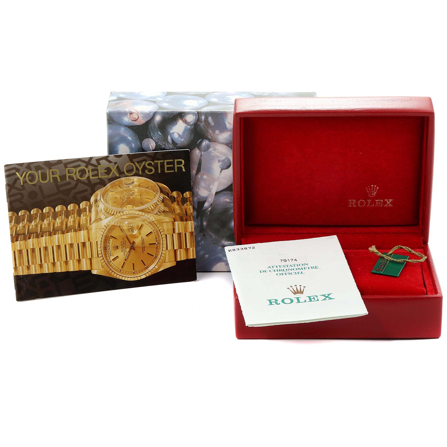 This image shows the packaging, booklet, tags, and an empty presentation box for a Datejust model by Rolex.