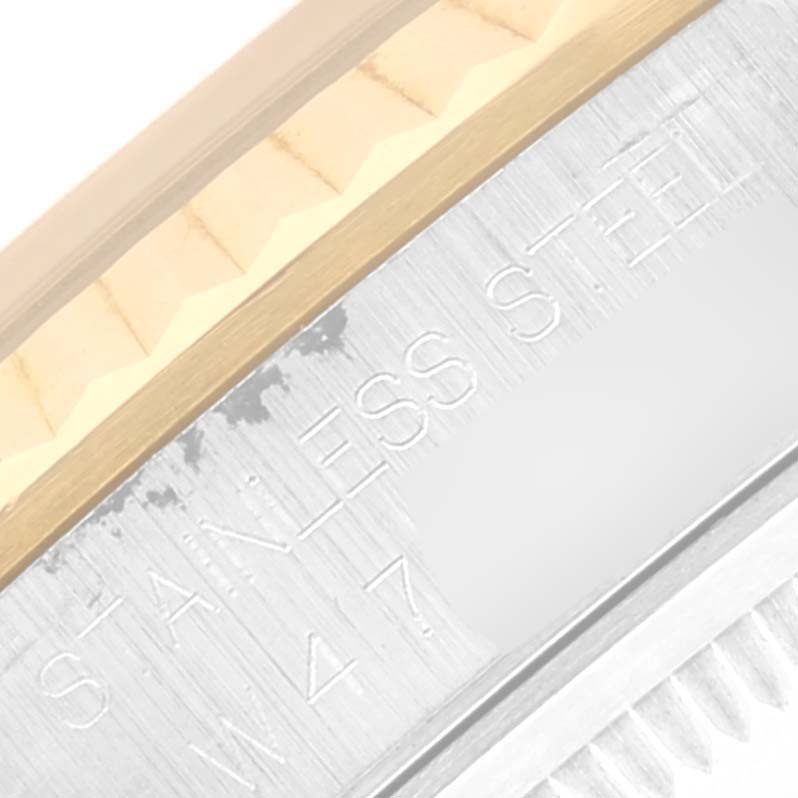 This image captures a close-up of the Rolex Datejust 16233 Men's Steel and Gold (two tone) Blue Dial 16233 Men's Steel and Gold (two tone) Blue Dial's bezel and casing, highlighting the fluted bezel and stainless steel.