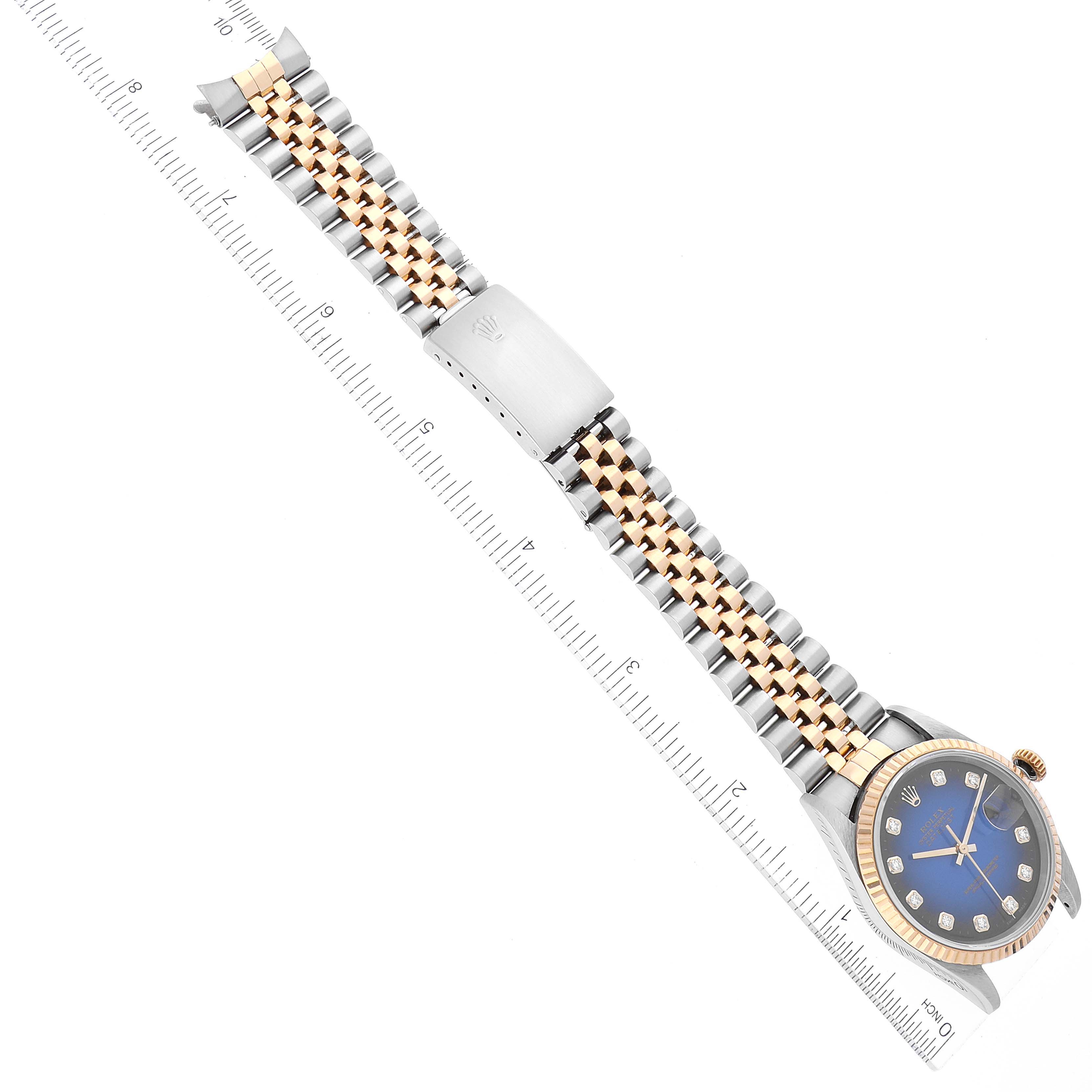 The image shows a Rolex Datejust 16233 Men's Steel and Gold (two tone) Blue Dial 16233 Men's Steel and Gold (two tone) Blue Dial watch from an overhead angle, highlighting the dial, bracelet, and clasp.