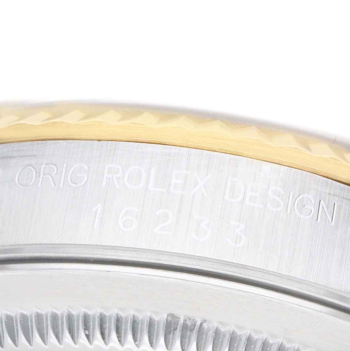 The image shows a close-up of the side of a Rolex Datejust 16233 Men's Steel and Gold (two tone) Champagne Dial watch, highlighting the engraved model number and a section of the bezel.
