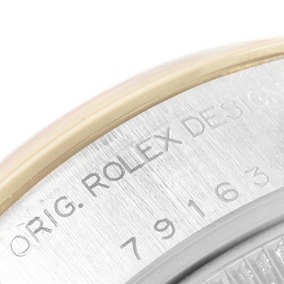 This is a close-up of the case back of a Rolex Datejust 79163 Women's Steel and Gold (two tone) White Dial 79163 Women's Steel and Gold (two tone) White Dial watch, showing the engraved text and model number.