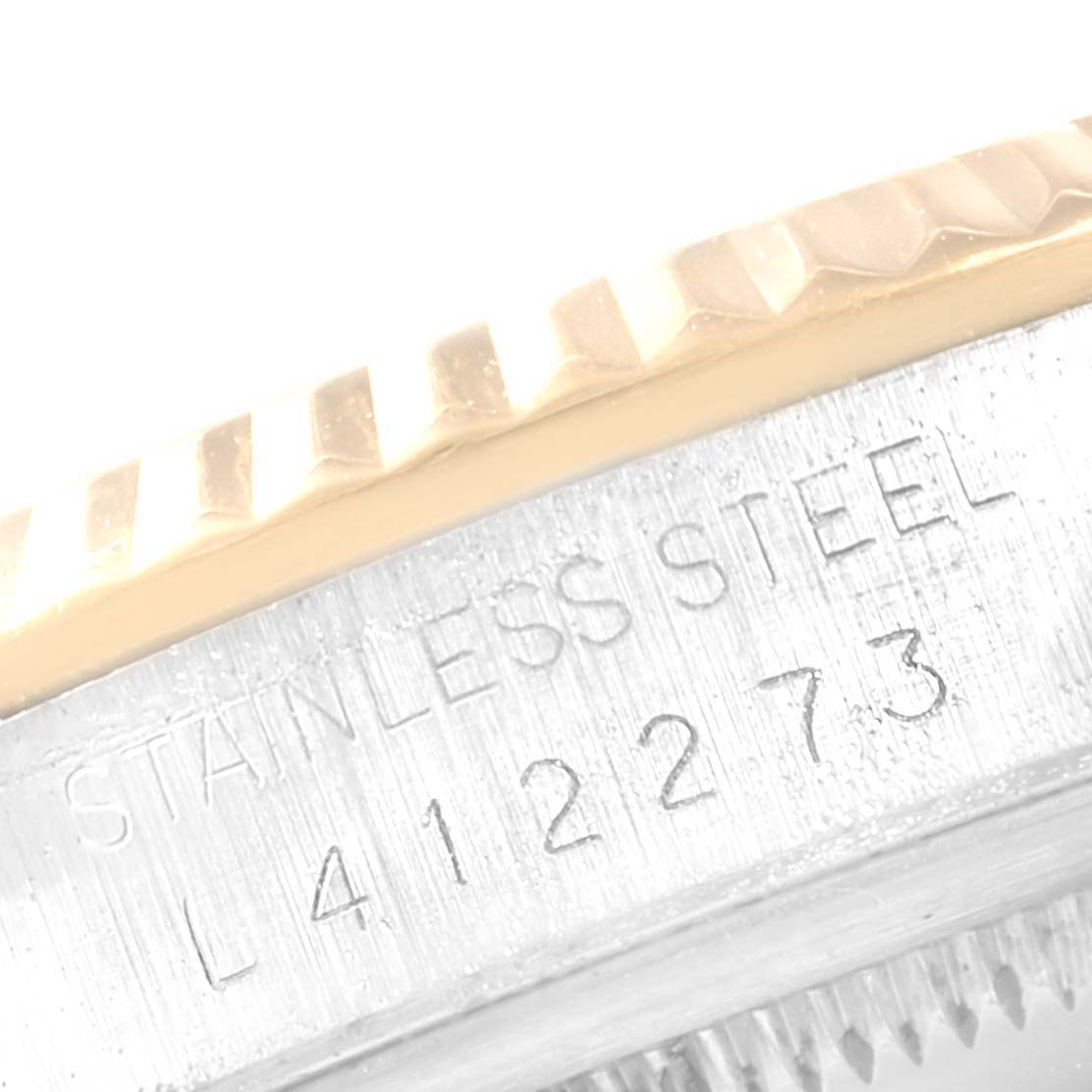 The image shows a close-up of the serial number and the stainless steel marking on the bezel of a Rolex Datejust 16233 Men
s Steel and Gold (two tone) Blue Dial 16233 Men
s Steel and Gold (two tone) Blue Dial watch.