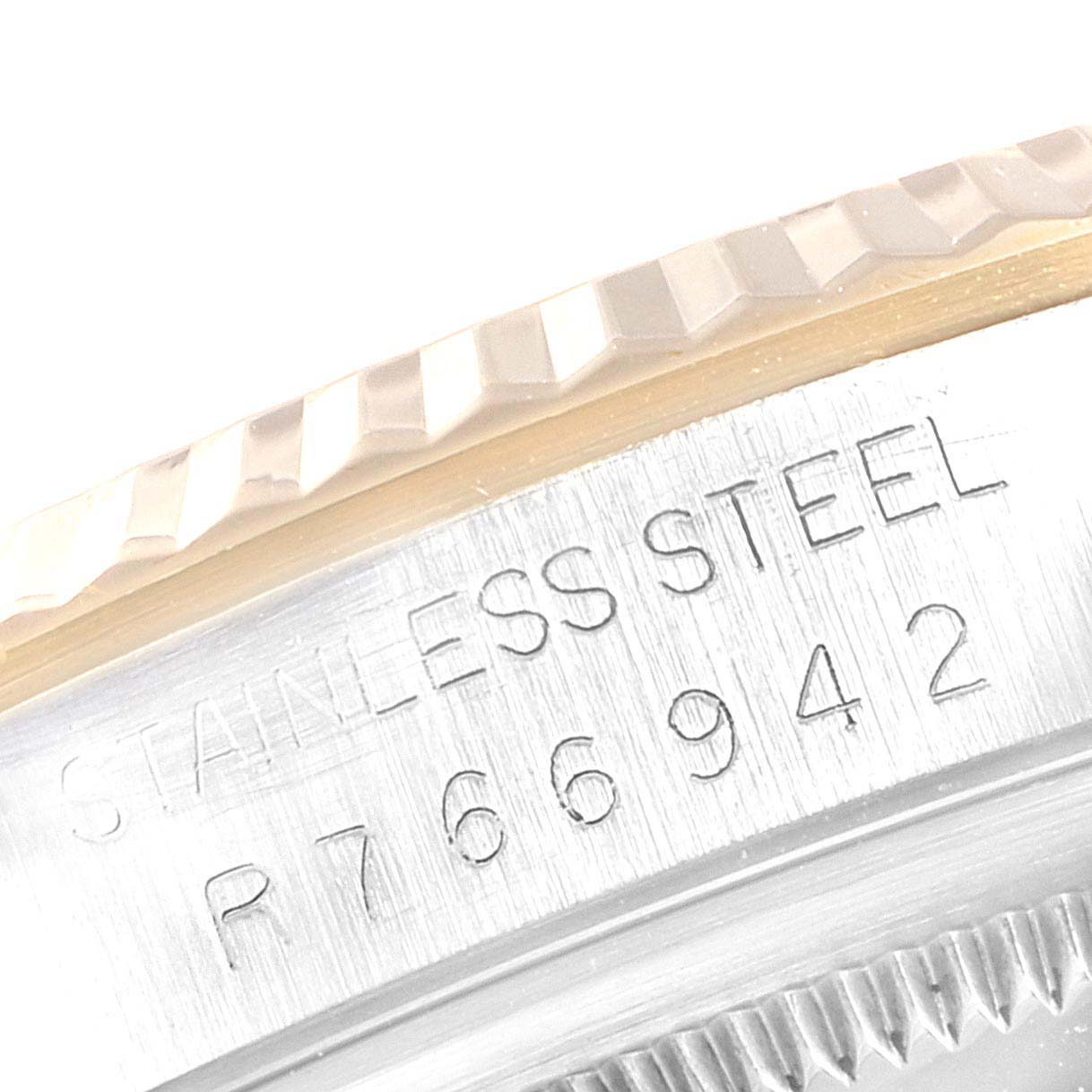 The image shows a close-up of the serial number engraving on the stainless steel casing beneath the fluted bezel of the Rolex Datejust 16233 Men
s Steel and Gold (two tone) Silver Dial 16233 Men
s Steel and Gold (two tone) Silver Dial.
