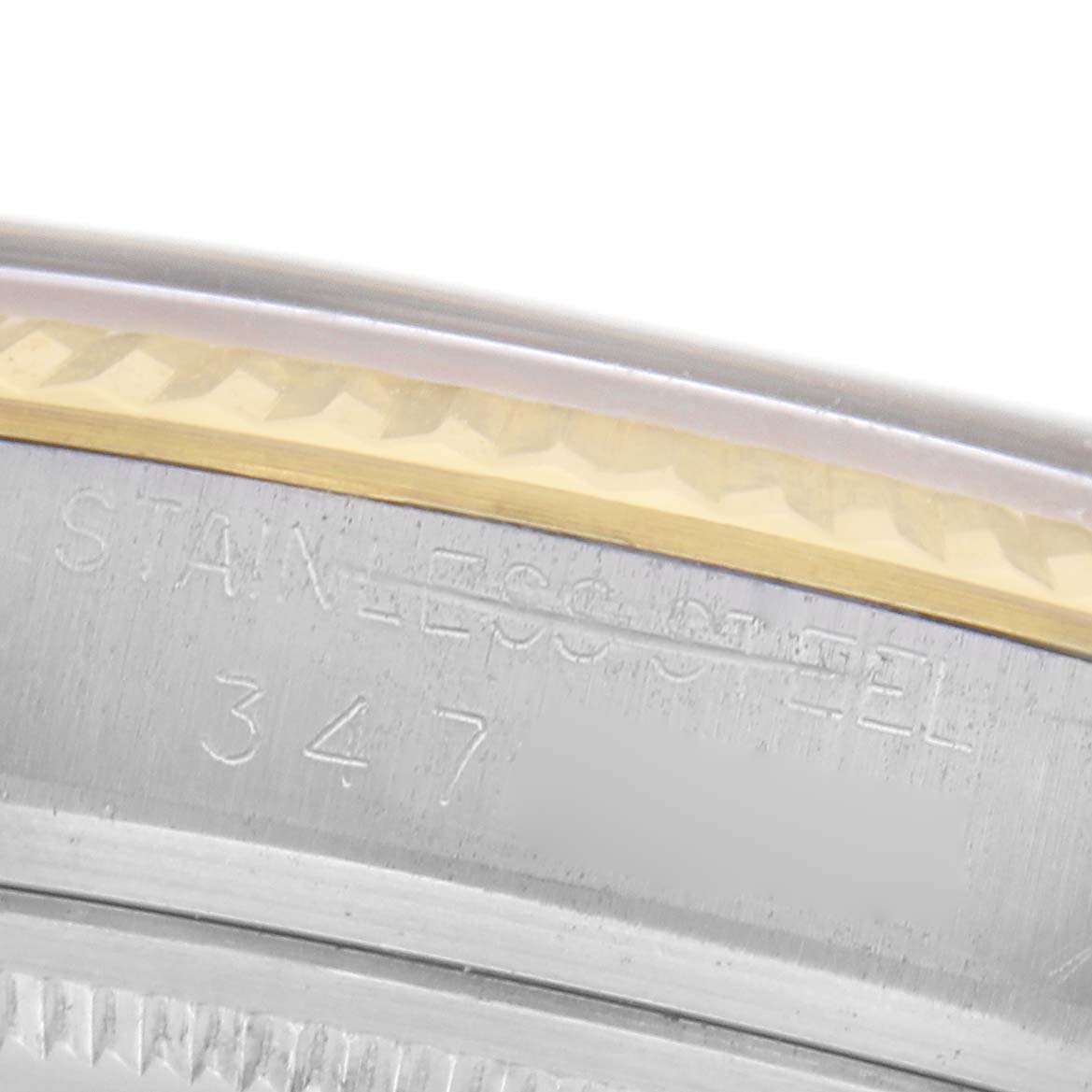 The image shows a close-up of the Rolex Datejust 1601 Men's Steel and Gold (two tone) Champagne Dial 1601 Men's Steel and Gold (two tone) Champagne Dial's side, highlighting the stainless steel and gold bezel with engraving details.