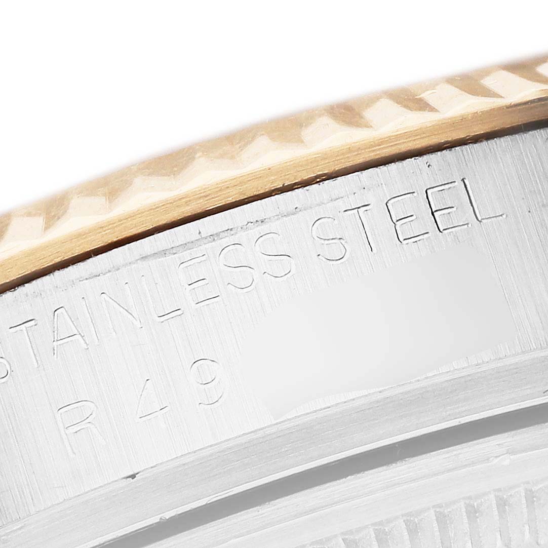This close-up of the Vintage Collection model by Rolex shows part of the steel case with engraved details and a portion of the bezel.