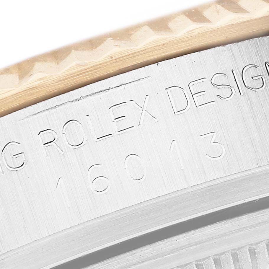 The image shows a close-up of the engraved bezel and case back of the Vintage Collection Rolex model 16013.