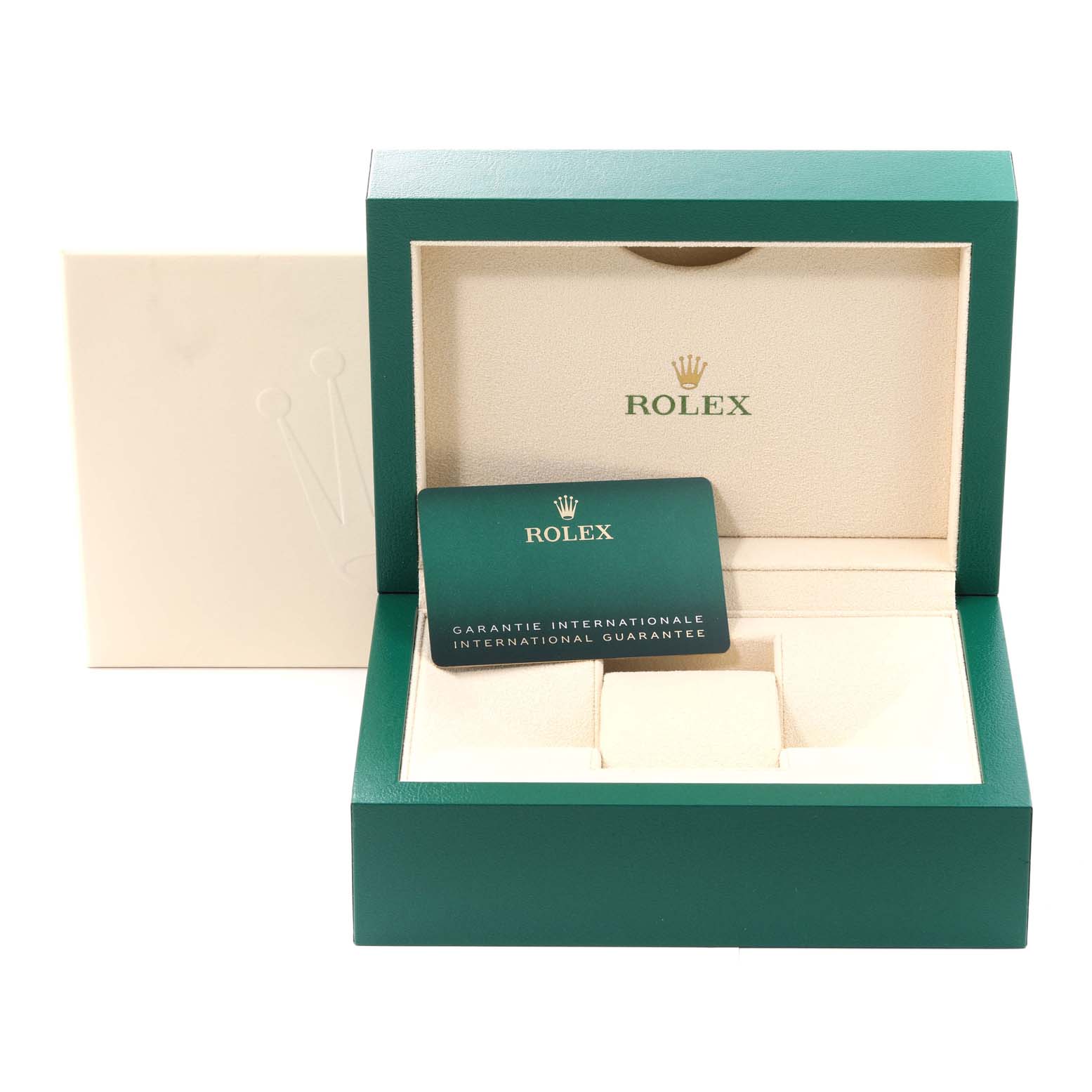 The image shows a Rolex green and beige Daytona model box with an international guarantee card placed inside.