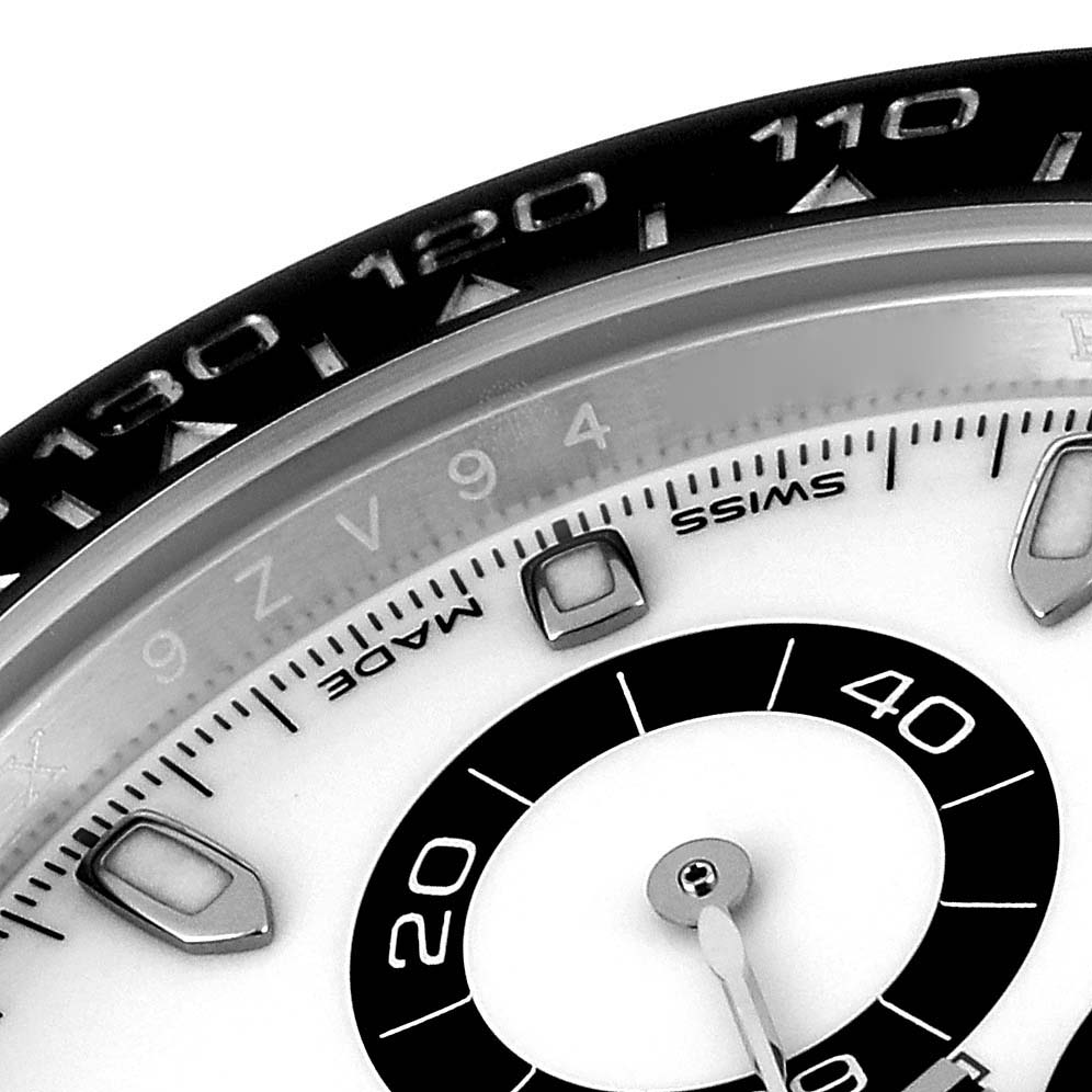 A close-up of the Rolex Daytona 116500 Men's Stainless Steel White Dial 116500 Men's Stainless Steel White Dial watch's dial and partial bezel, showcasing the chronograph sub-dials and numerals.