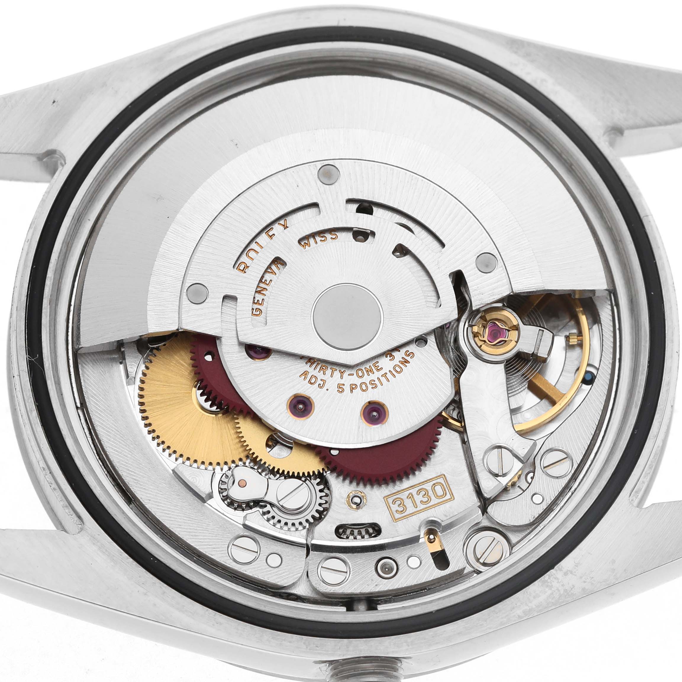 The image shows the movement mechanism of the Rolex Explorer 114270 Men's Stainless Steel Black Dial, viewed from the rear with visible gears and components.