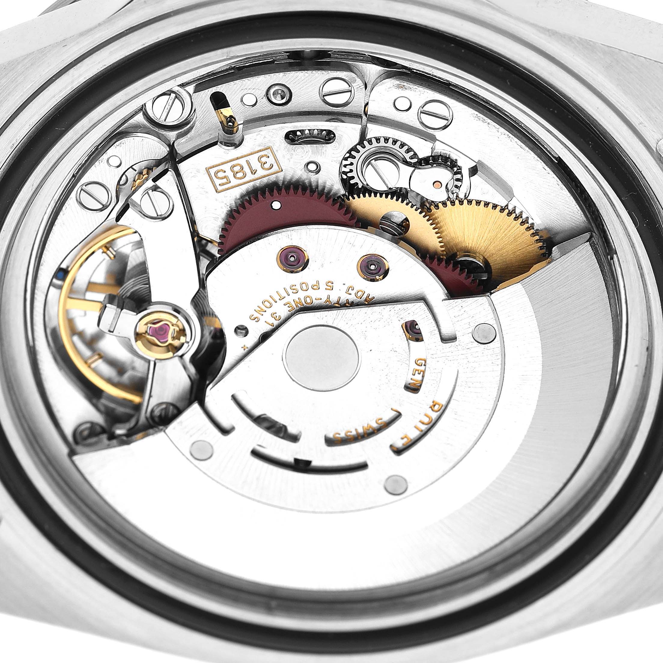 The image shows the movement of a Rolex Explorer 16570 Men's Stainless Steel White Dial watch, highlighting gears and mechanical components from a top-down angle.