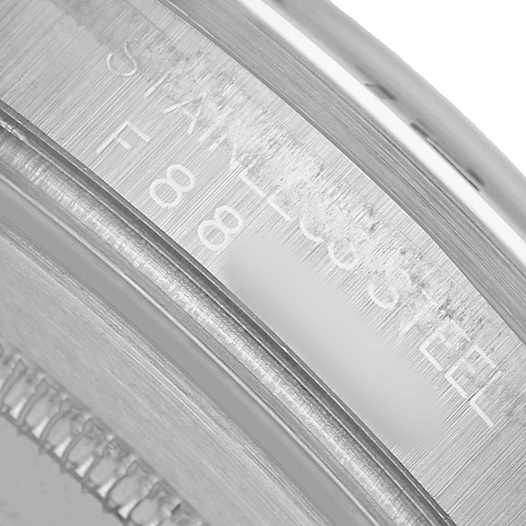 The image shows a close-up of the case and inner bezel of a Rolex Explorer 16570 Men's Stainless Steel White Dial, highlighting the "STAINLESS STEEL" engraving.