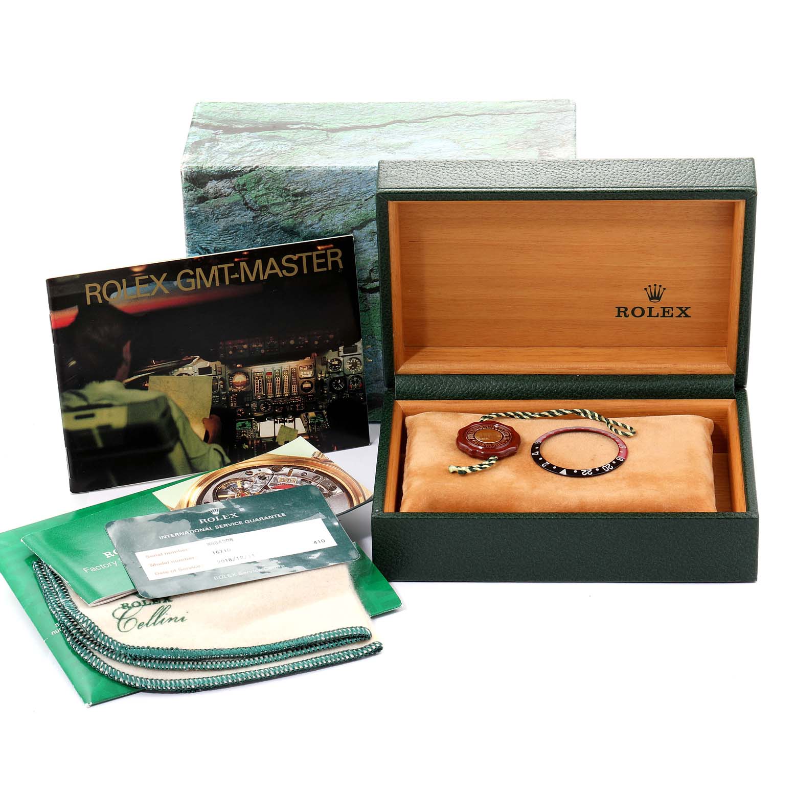 The image shows a Rolex GMT-Master 16710 Men
s Stainless Steel Black Dial 16710 Men
s Stainless Steel Black Dial watch box, manual, accessories, and service card from a front angle.