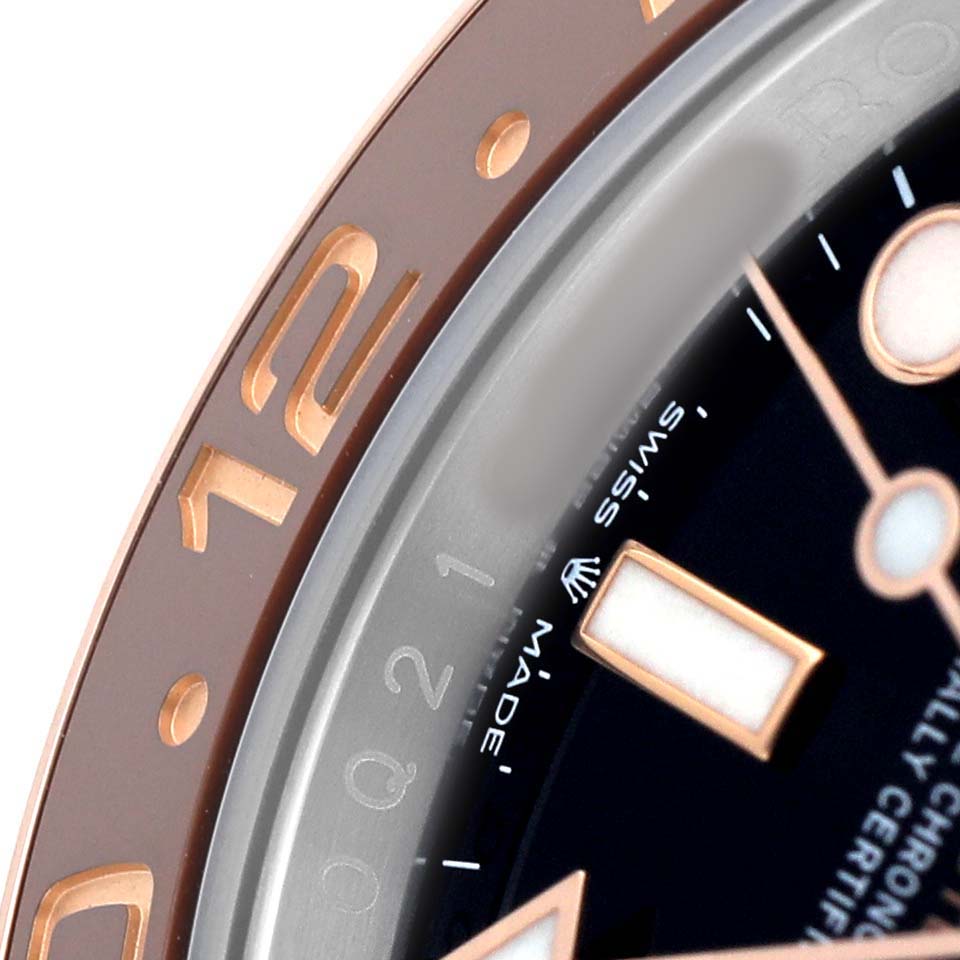 The image shows a close-up of the Rolex GMT-Master M126711CHNR - 0002 Men's Steel and Gold (two tone) Black Dial's bezel, dial, and hour markers, highlighting its details.