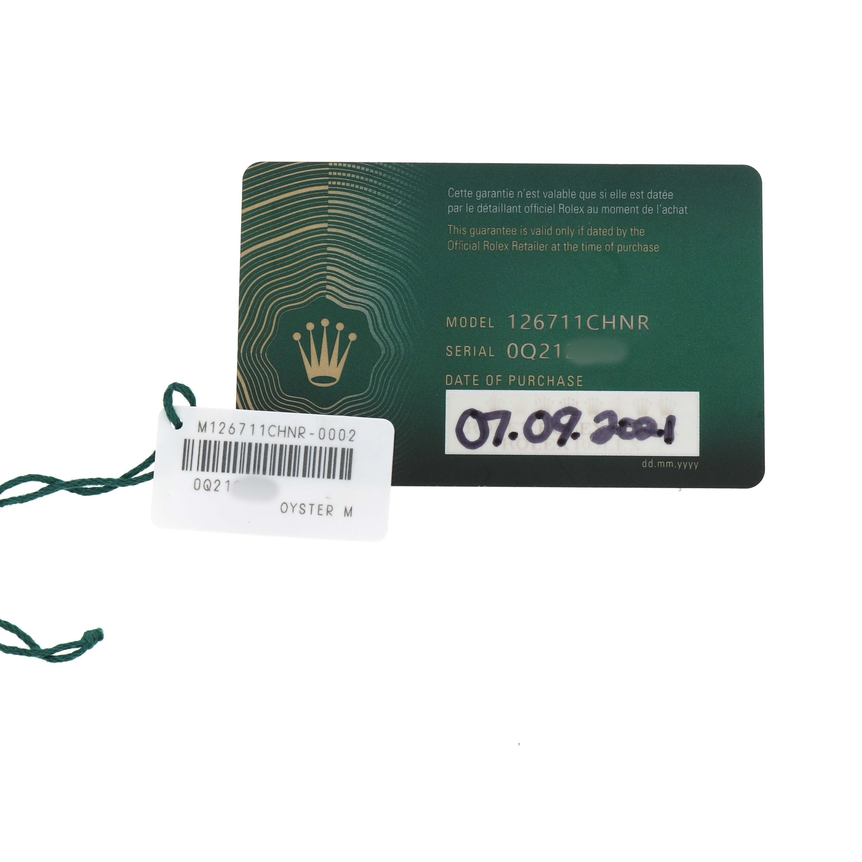 The image shows a Rolex warranty card for the GMT-Master model, including model and serial numbers, with a date of purchase.