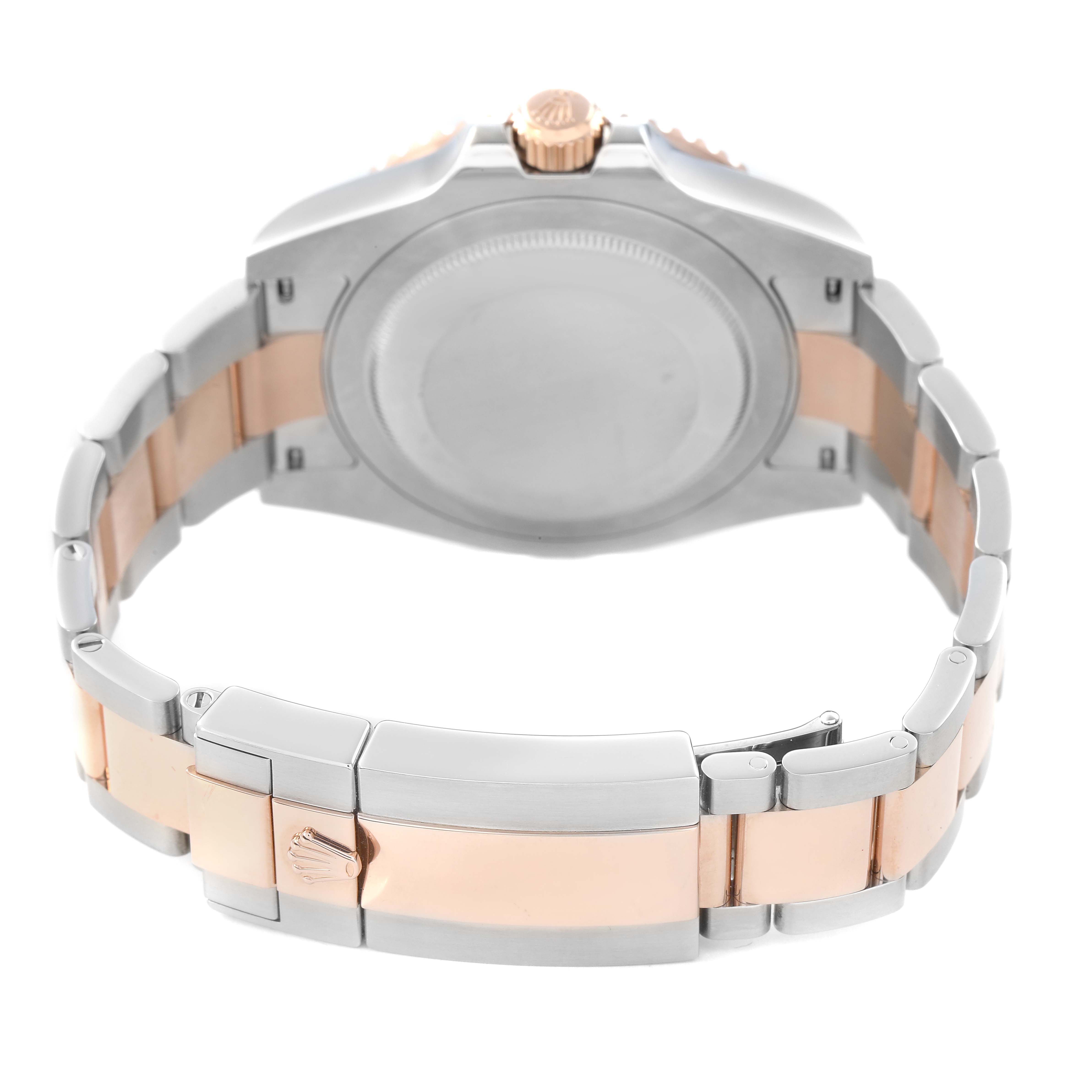 The image shows the back of the Rolex GMT-Master M126711CHNR - 0002 Men's Steel and Gold (two tone) Black Dial watch, displaying the bracelet and clasp with a focus on the crown logo.