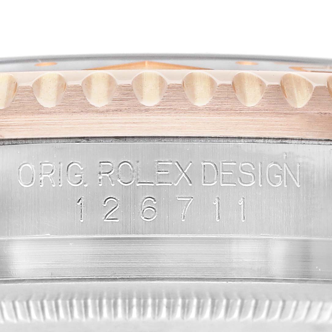 The image shows a close-up of the side engraving on a Rolex GMT-Master M126711CHNR - 0002 Men's Steel and Gold (two tone) Black Dial, displaying the model number and design text.
