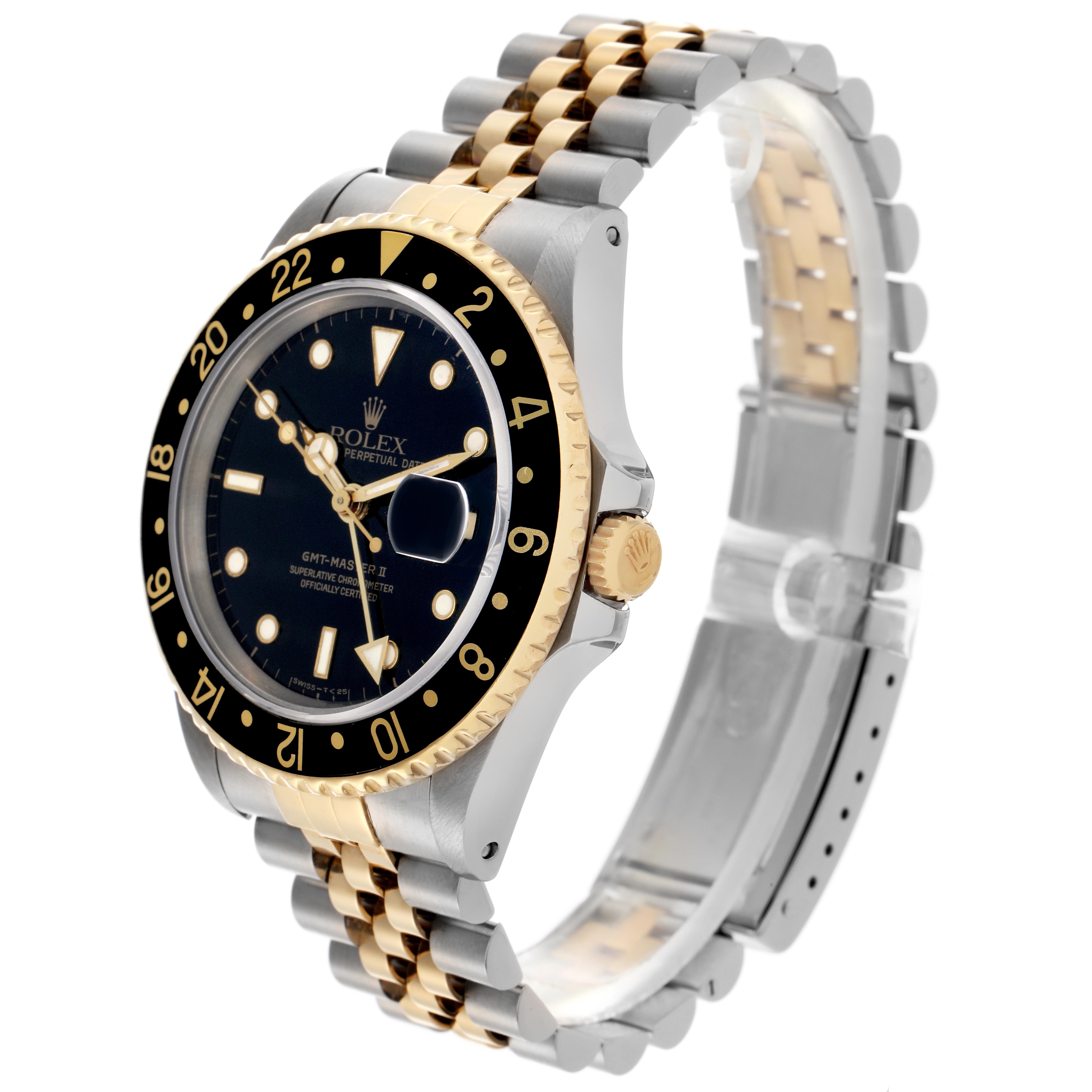 The Rolex GMT-Master 16713 Men's Steel and Gold (two tone) Black Dial 16713 Men's Steel and Gold (two tone) Black Dial watch is shown at a three-quarter angle, displaying the dial, bezel, crown, and two-tone bracelet.