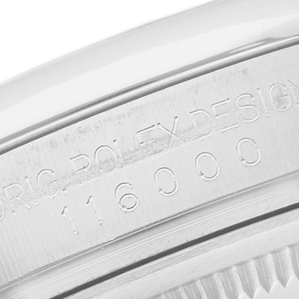 This image shows a close-up of the engraved model and serial number on the side of an Oyster Perpetual Rolex watch.