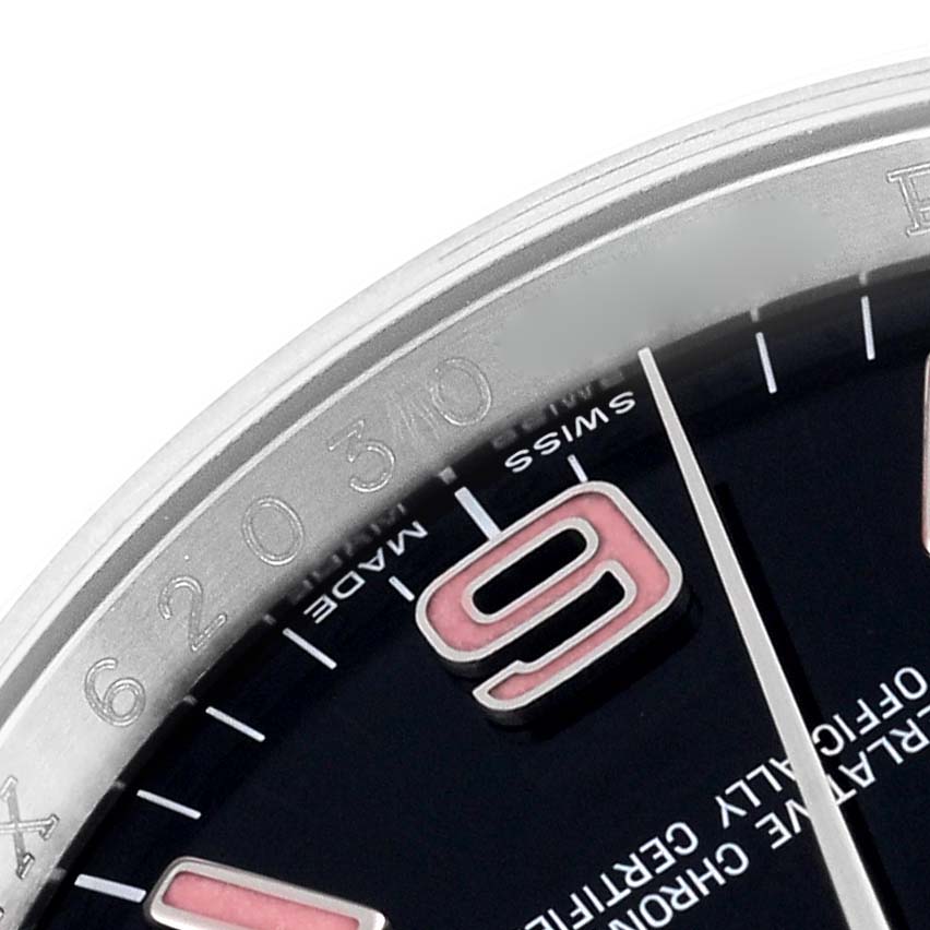 This close-up of the Rolex Oyster Perpetual 116000 Men
s Stainless Steel Black Dial 116000 Men
s Stainless Steel Black Dial watch shows a portion of the dial and bezel, including the 
9
 marker.