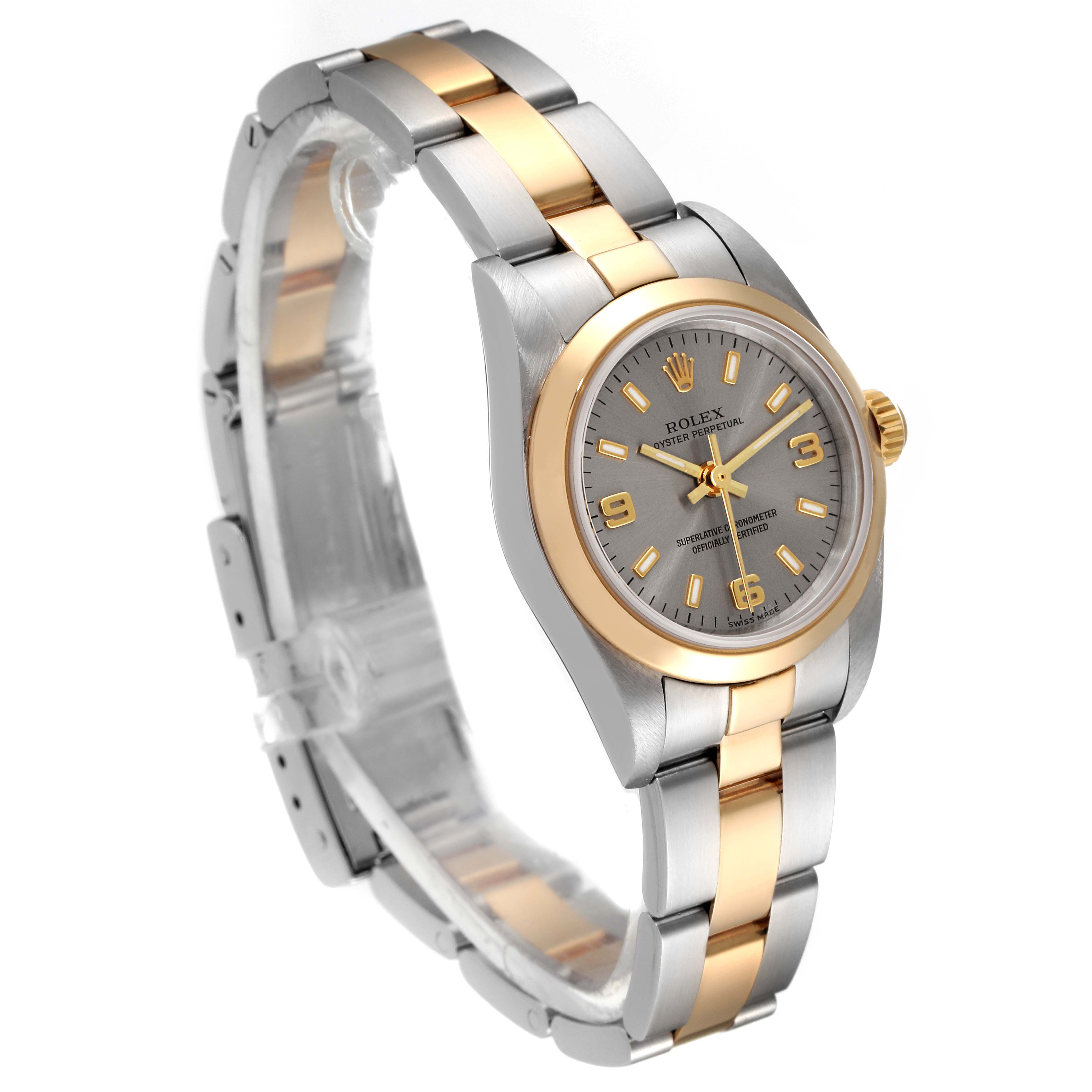 This Rolex Oyster Perpetual 76183 Women
s Steel and Gold (two tone) Grey Dial 76183 Women
s Steel and Gold (two tone) Grey Dial watch is shown at a slight angle, highlighting its bi-metal bracelet, bezel, and dial.