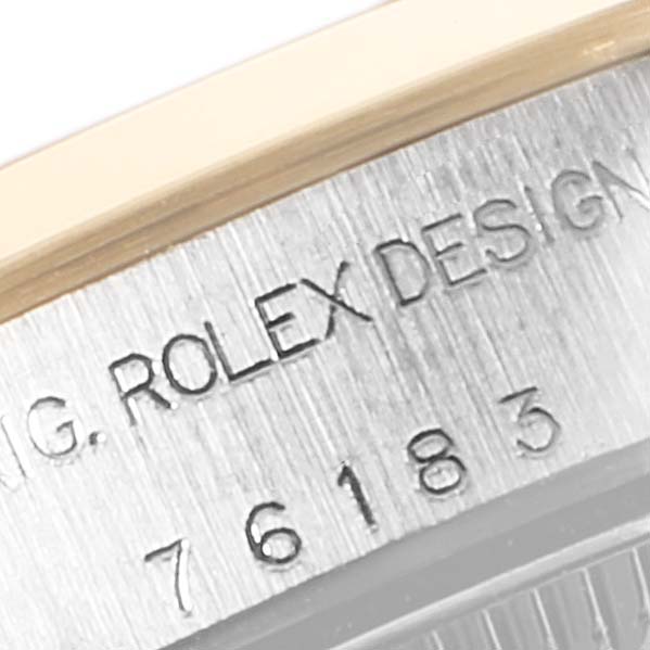 The image shows a close-up of the outer rim and engraved serial number of the Rolex Oyster Perpetual 76183 Women
s Steel and Gold (two tone) Grey Dial 76183 Women
s Steel and Gold (two tone) Grey Dial watch.