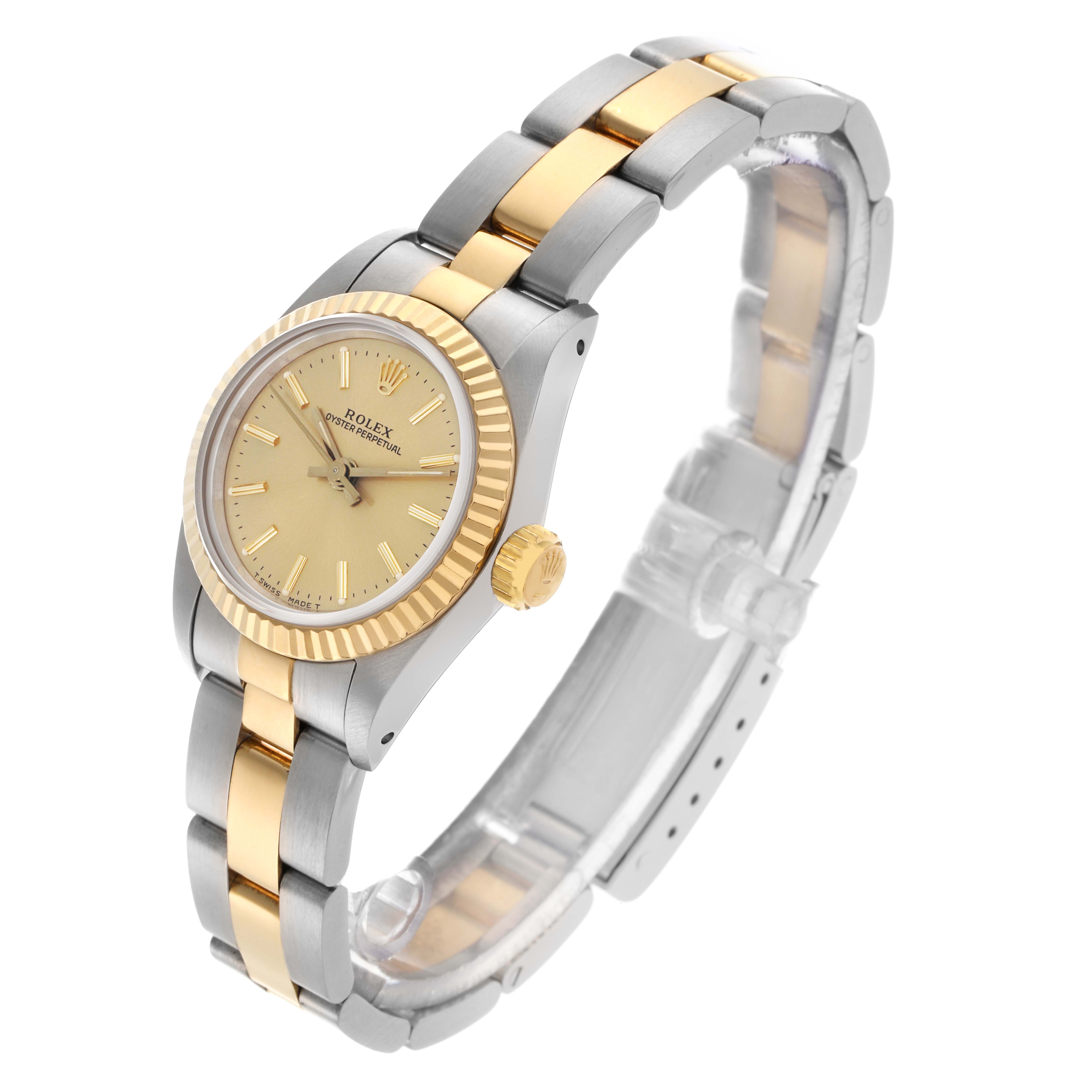 The Rolex Oyster Perpetual 67193 Women's Steel and Gold (two tone) Champagne Dial 67193 Women's Steel and Gold (two tone) Champagne Dial watch is shown at an angled side view, highlighting its two-tone bracelet and fluted bezel.