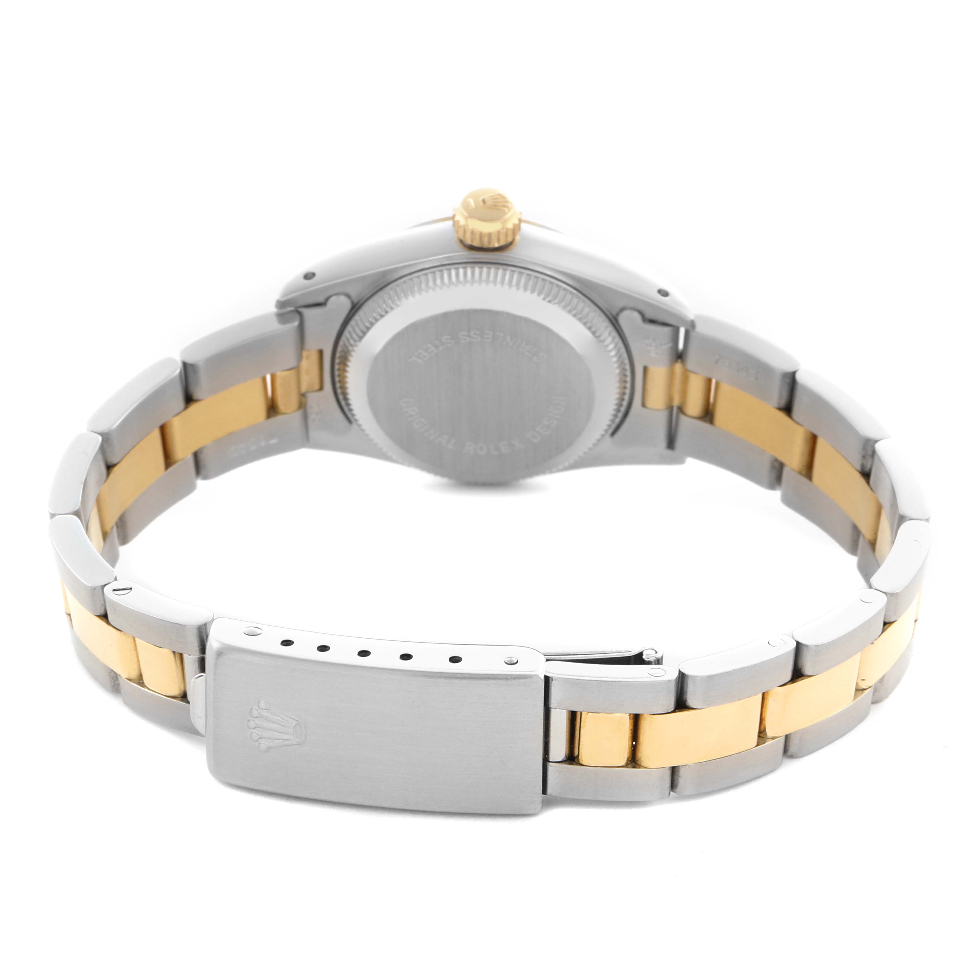 The Rolex Oyster Perpetual 67193 Women's Steel and Gold (two tone) Champagne Dial 67193 Women's Steel and Gold (two tone) Champagne Dial watch is shown from the rear at a slight downward angle, highlighting the case back and two-tone bracelet.
