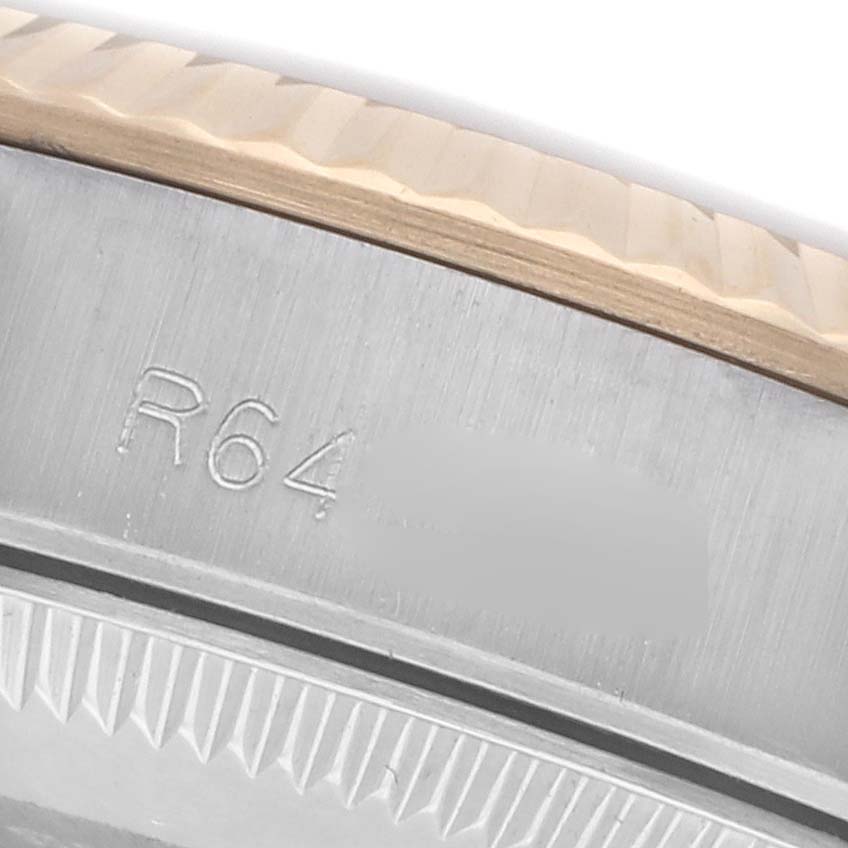 The image shows a close-up of the edge and engravings on the bezel of a Rolex Oyster Perpetual 67193 Women's Steel and Gold (two tone) Champagne Dial 67193 Women's Steel and Gold (two tone) Champagne Dial watch.