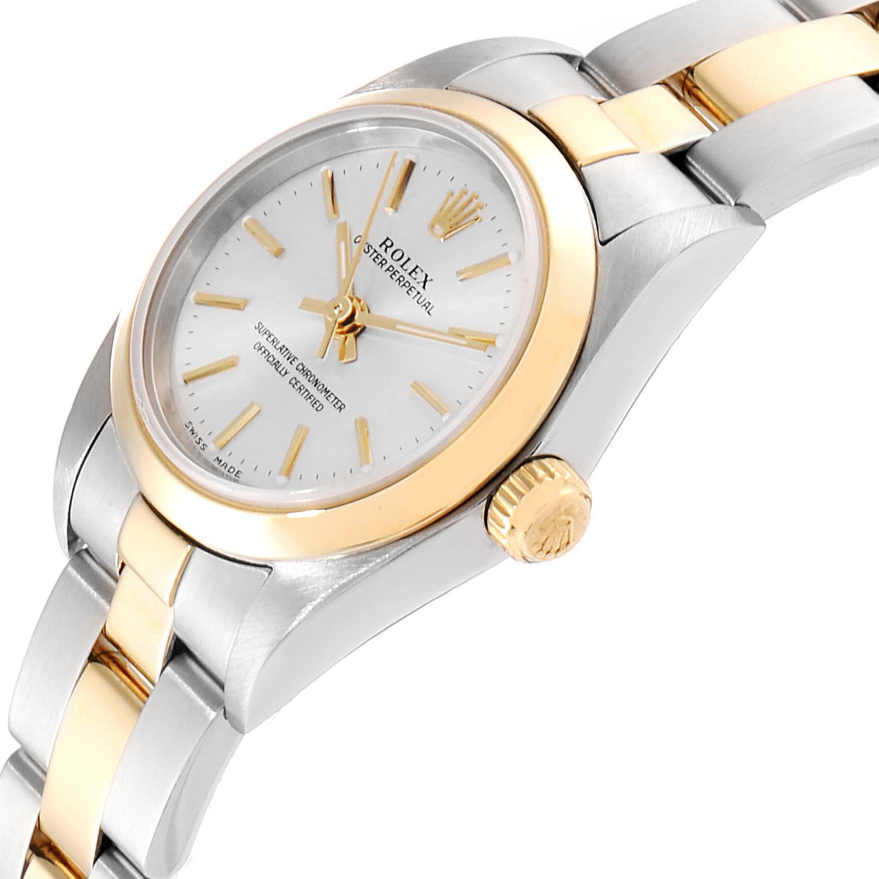 This image shows a Rolex Oyster Perpetual 76183 Women's Steel and Gold (two tone) Silver Dial 76183 Women's Steel and Gold (two tone) Silver Dial watch at an angle highlighting the dial, bezel, crown, and part of the bracelet.