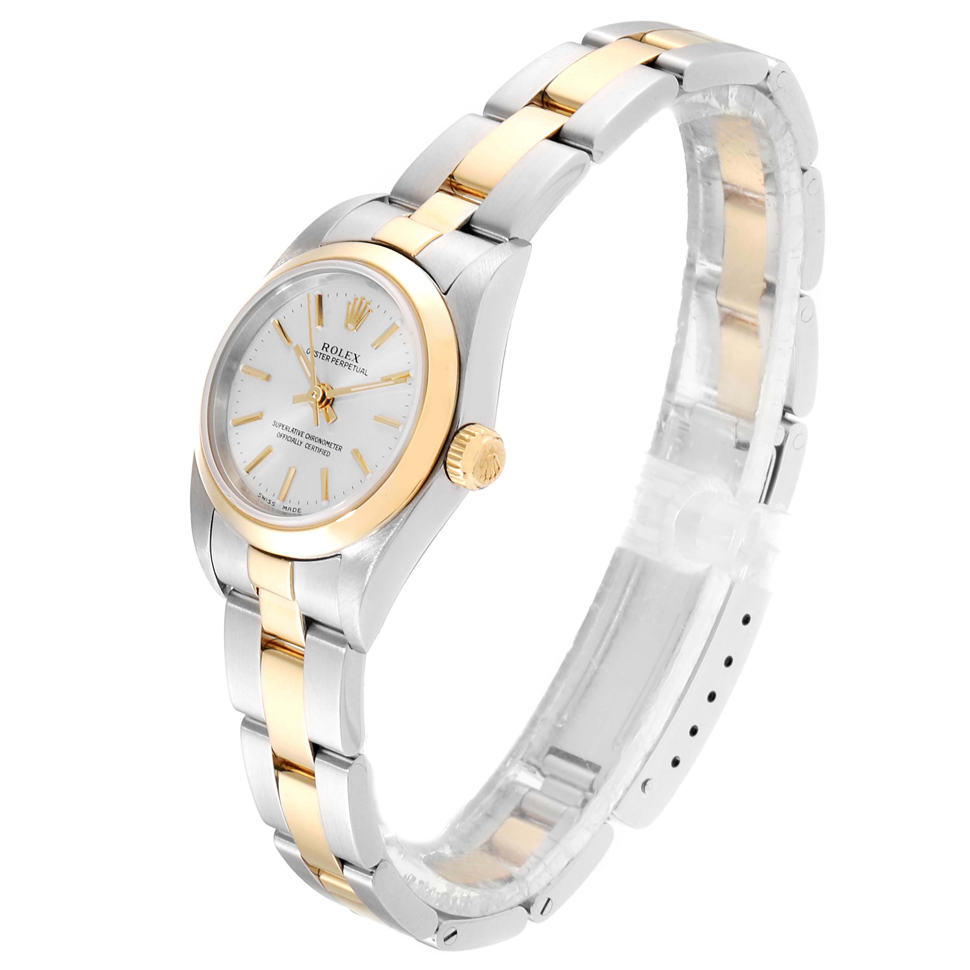 The Rolex Oyster Perpetual 76183 Women's Steel and Gold (two tone) Silver Dial 76183 Women's Steel and Gold (two tone) Silver Dial watch is shown at a three-quarter angle, highlighting its bi-metal bracelet and white dial.