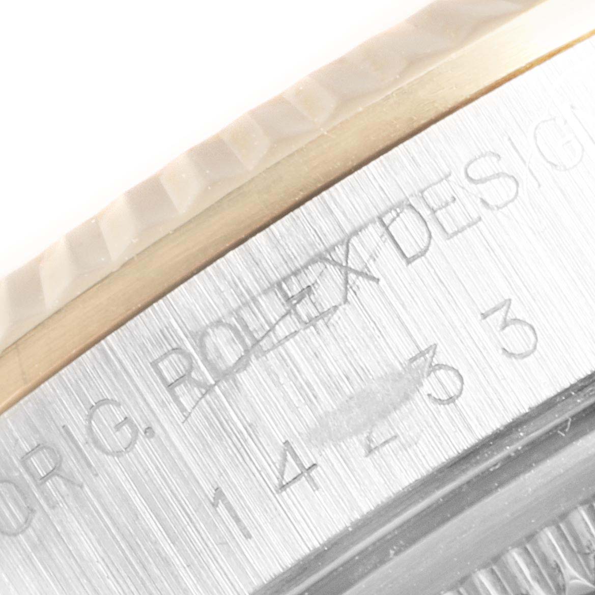 This image shows a macro shot of the engraved bezel and edge of the case of a Rolex Oyster Perpetual 14233 Men's Steel and Gold (two tone) Grey Dial 14233 Men's Steel and Gold (two tone) Grey Dial watch.