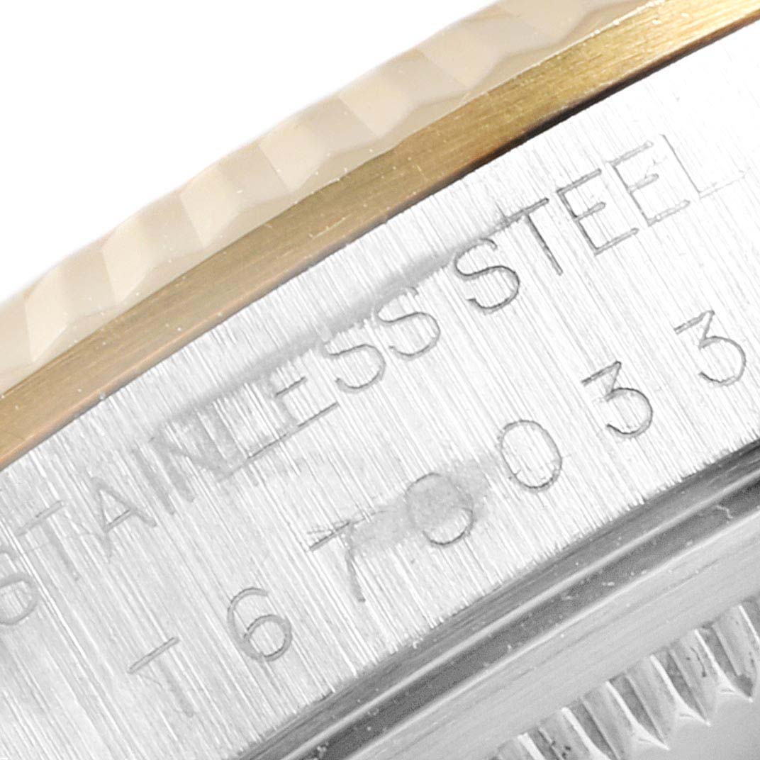 This is a close-up of the case and bezel edge showing engravings for the Rolex Oyster Perpetual 14233 Men's Steel and Gold (two tone) Grey Dial 14233 Men's Steel and Gold (two tone) Grey Dial watch.