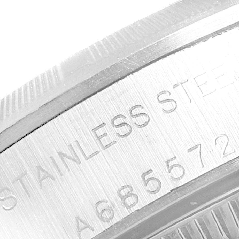 The image shows a close-up of the case back of a Rolex Oyster Perpetual 76030 Women
s Stainless Steel White Dial 76030 Women
s Stainless Steel White Dial watch, highlighting the stainless steel engraving.