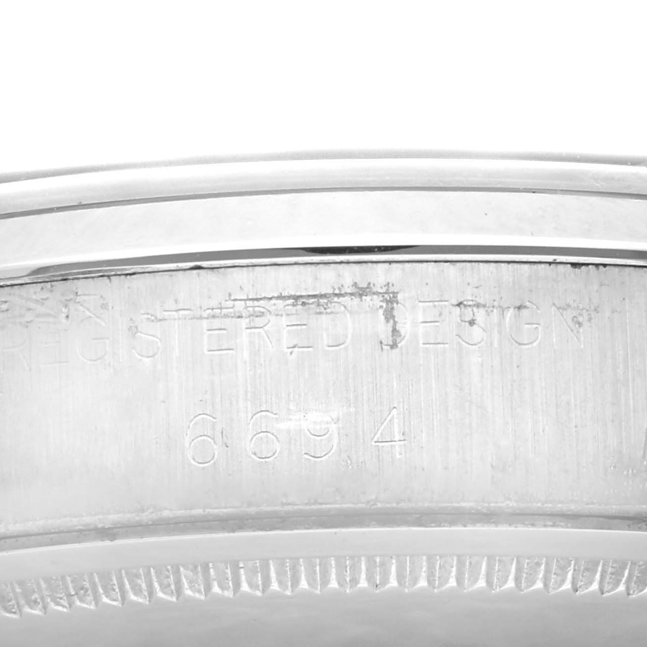 This is a close-up image displaying the rim and engraved serial number of a Vintage Collection model Rolex watch.