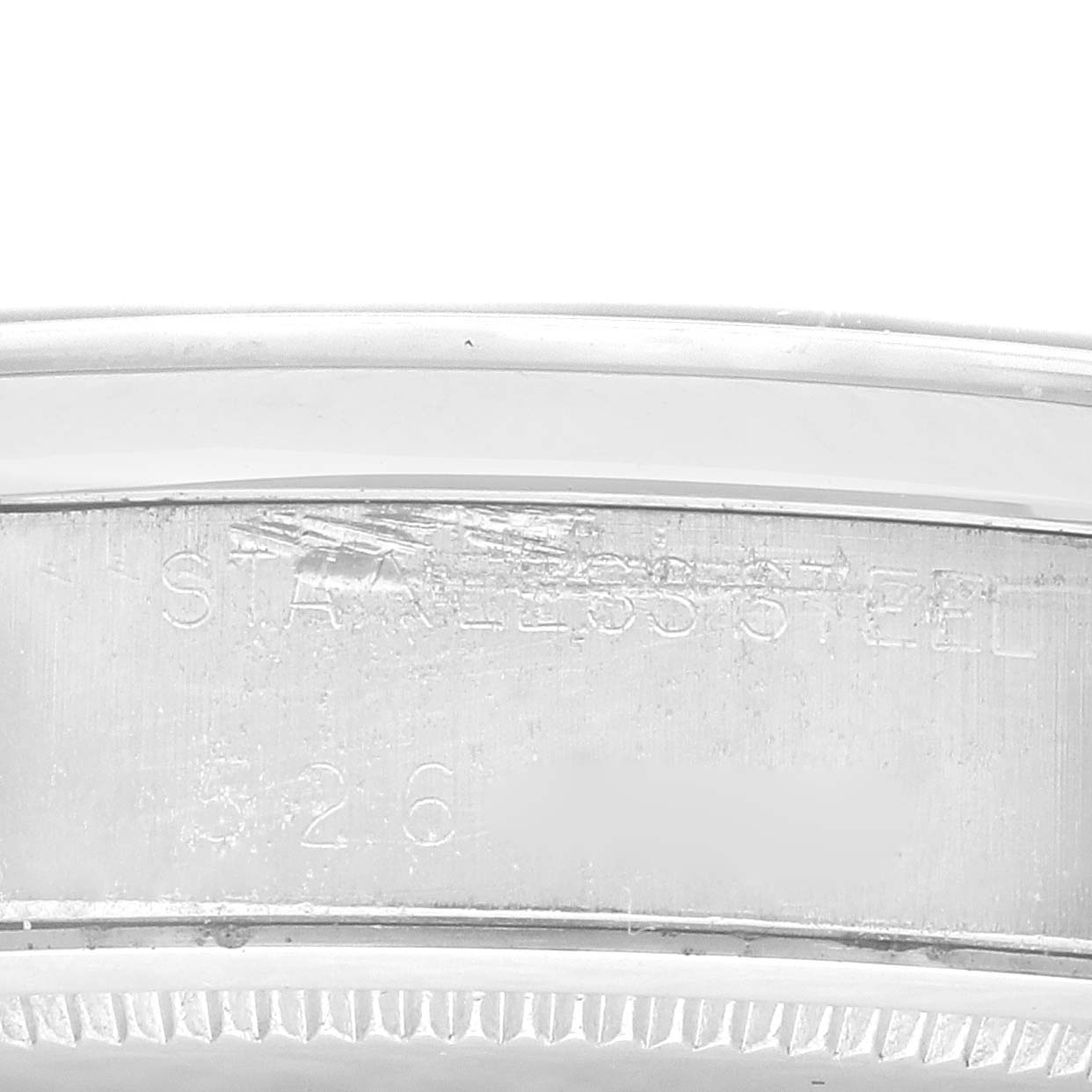 This image shows a close-up view of the side of a Rolex Vintage Collection 6694 Men's Stainless Steel Silver Dial 6694 Men's Stainless Steel Silver Dial watch, highlighting its stainless steel material and part of the serial number.