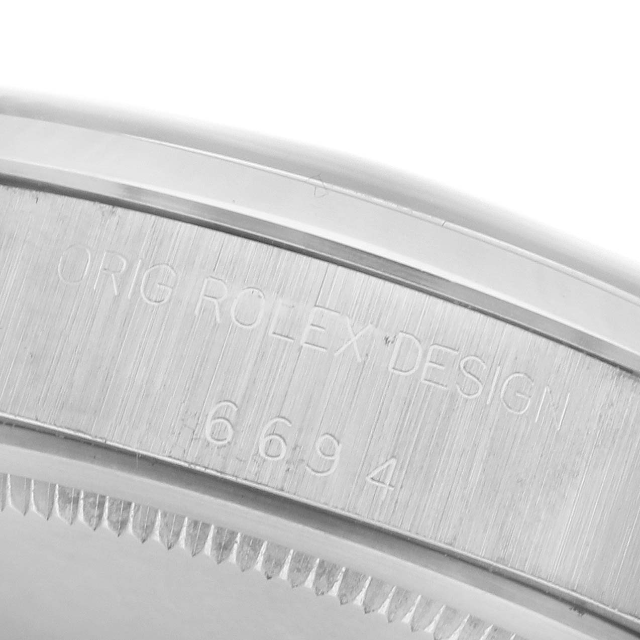 The image shows a close-up of the side of a Rolex Date 6694 Men's Stainless Steel Silver Dial 6694 Men's Stainless Steel Silver Dial watch case with engraved details.