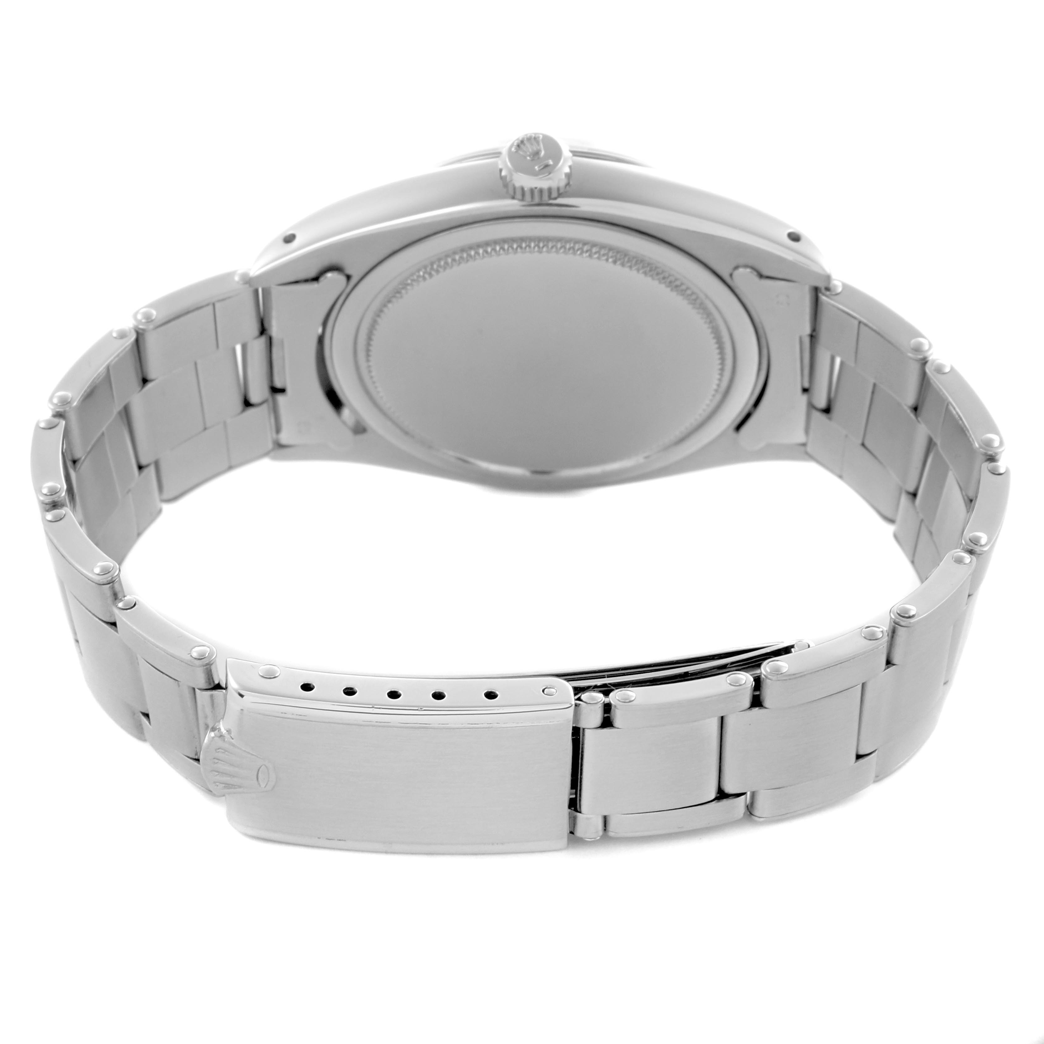The image shows the back view of a Rolex Date 6694 Men's Stainless Steel Silver Dial 6694 Men's Stainless Steel Silver Dial model watch, highlighting the closed clasp and bracelet links.