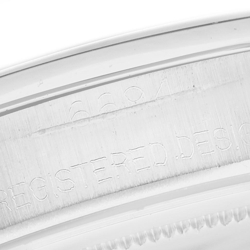 The image shows a partial view of the case side with engraved markings on a Rolex Date 6694 Men's Stainless Steel Silver Dial 6694 Men's Stainless Steel Silver Dial model.