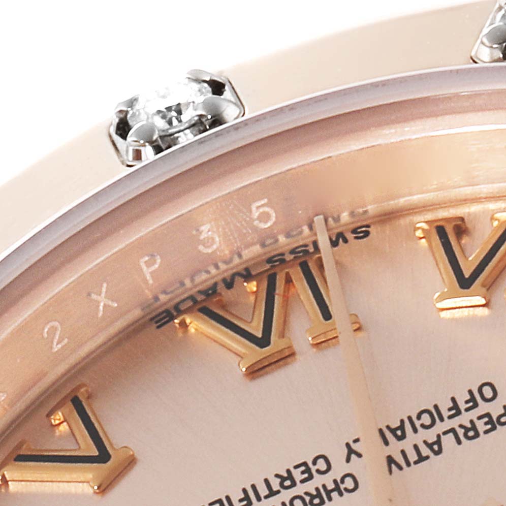 This close-up angle of the Rolex Pearlmaster 80315 Women's Rose Gold Pink Dial 80315 Women's Rose Gold Pink Dial watch shows the bezel with diamonds, part of the dial, and the Roman numeral hour markers.