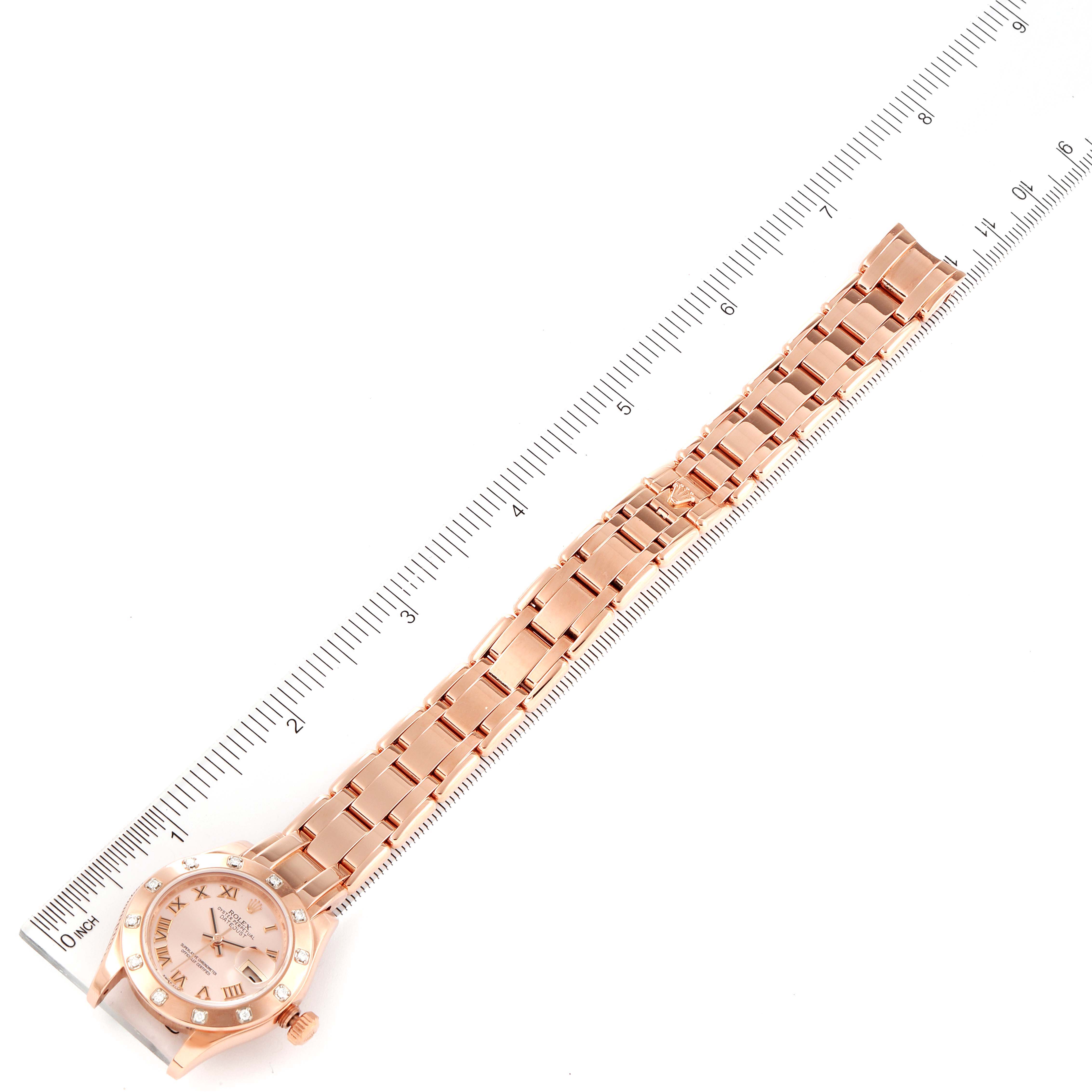 The image shows a Rolex Pearlmaster 80315 Women's Rose Gold Pink Dial 80315 Women's Rose Gold Pink Dial watch laid flat with its bracelet extended alongside a ruler for measurement.