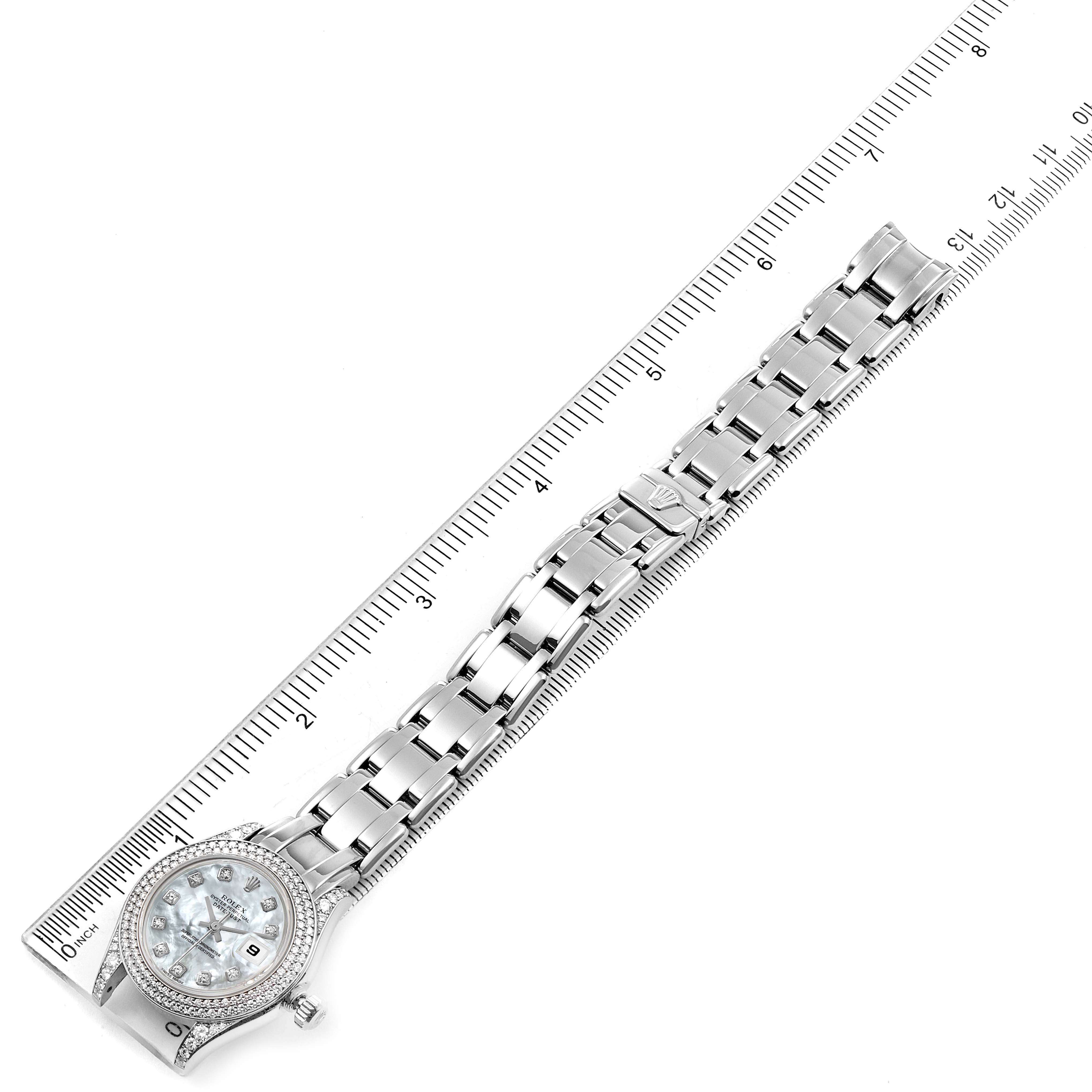 The image shows a Rolex Pearlmaster 69359 Women's White Gold Mother of Pearl Dial 69359 Women's White Gold Mother of Pearl Dial watch laid flat with its face, bezel, and entire bracelet alongside a ruler.
